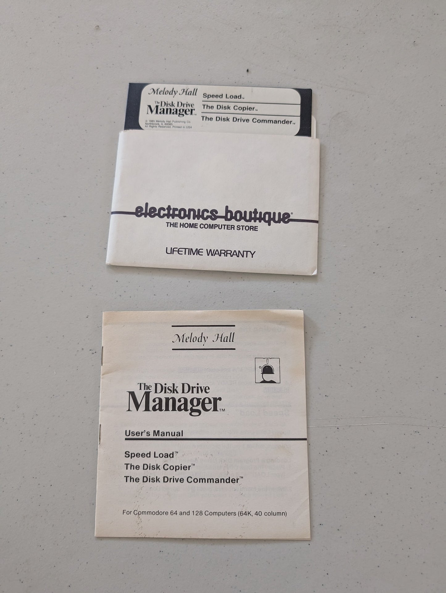 Melody Hall Disk Drive Manager 5.25 floppy disk label featuring Speed Load, Disk Copier, and Drive Commander 1985 with instructions