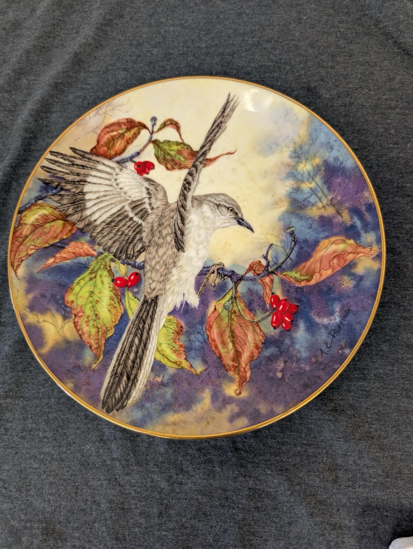A.E. Ruffing Mockingbird plate featuring a bird in flight with red berries