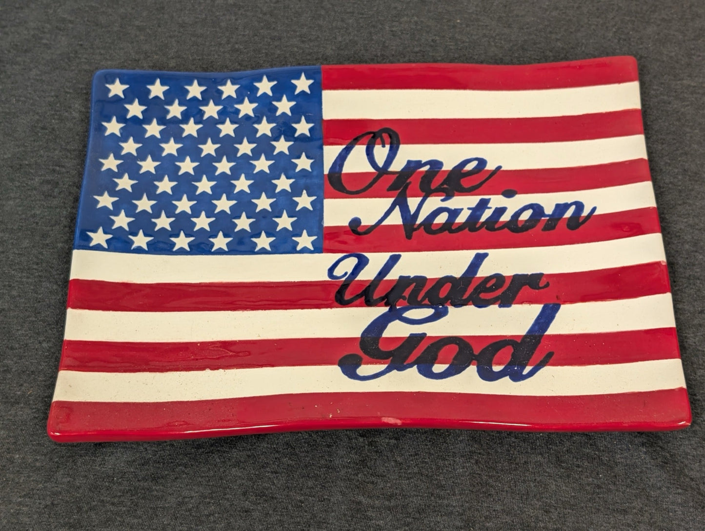 Rectangular ceramic tray painted like an American flag with text One Nation Under God.