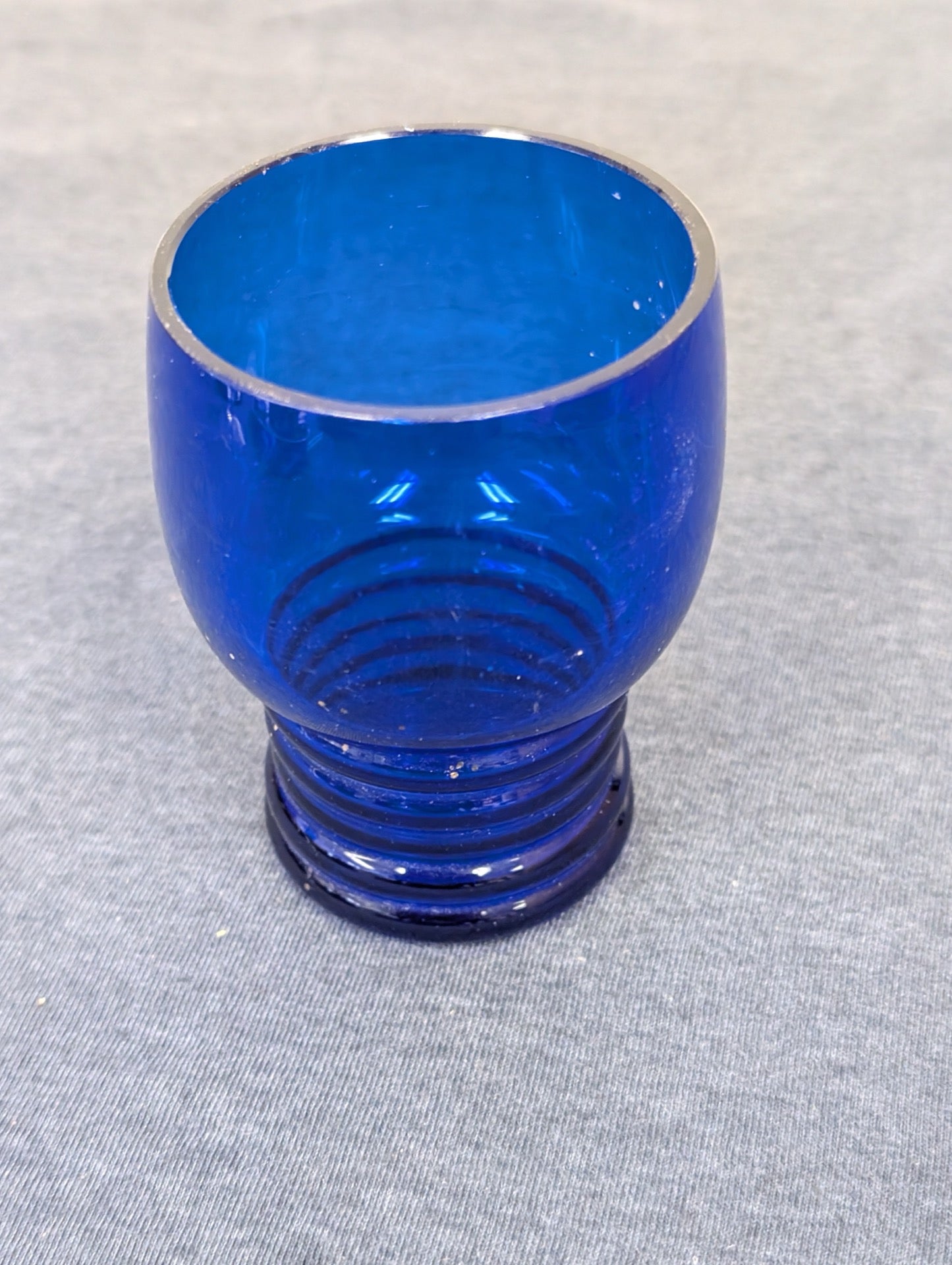 Small cobalt blue glass tumbler with a deeply ribbed base.
