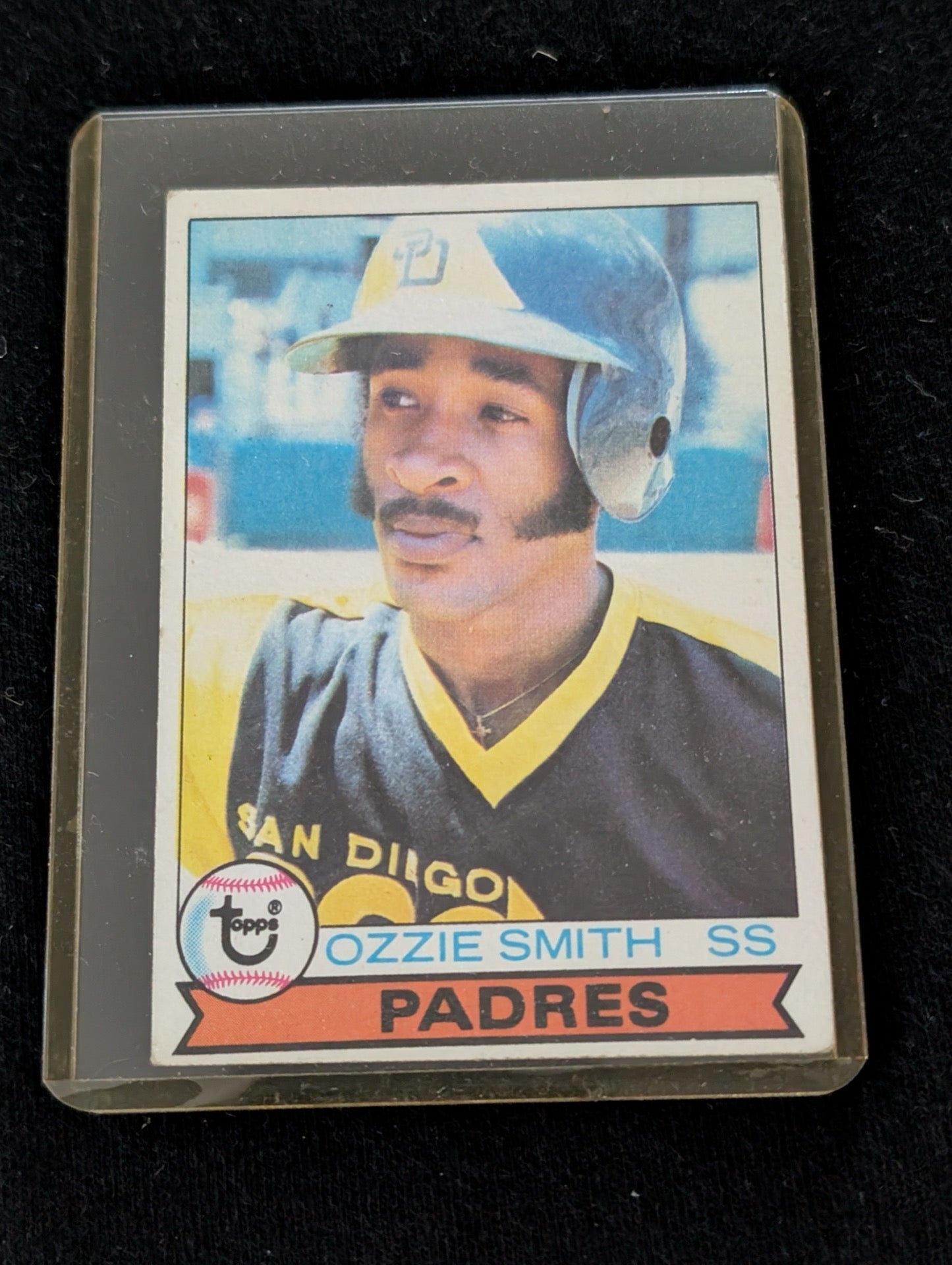 Vintage 1979 Topps Ozzie Smith Rookie Card #116 for the San Diego Padres in a top loader sleeve.
