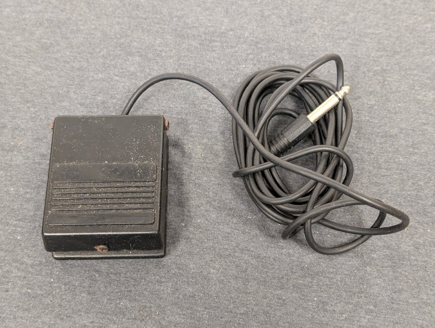 Black square foot pedal with 1/4 inch audio jack