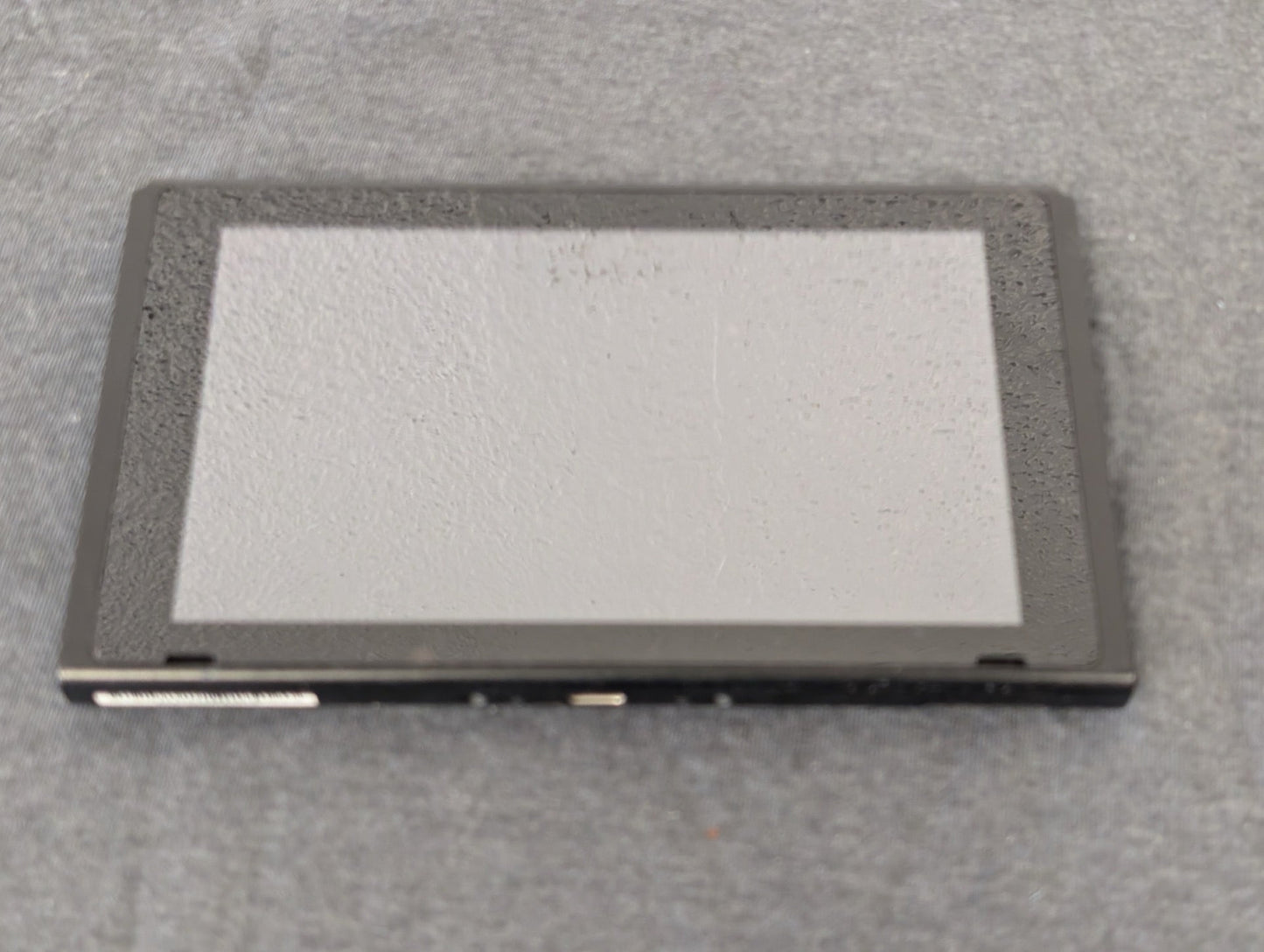 Front of a Nintendo Switch tablet screen showing heavy wear