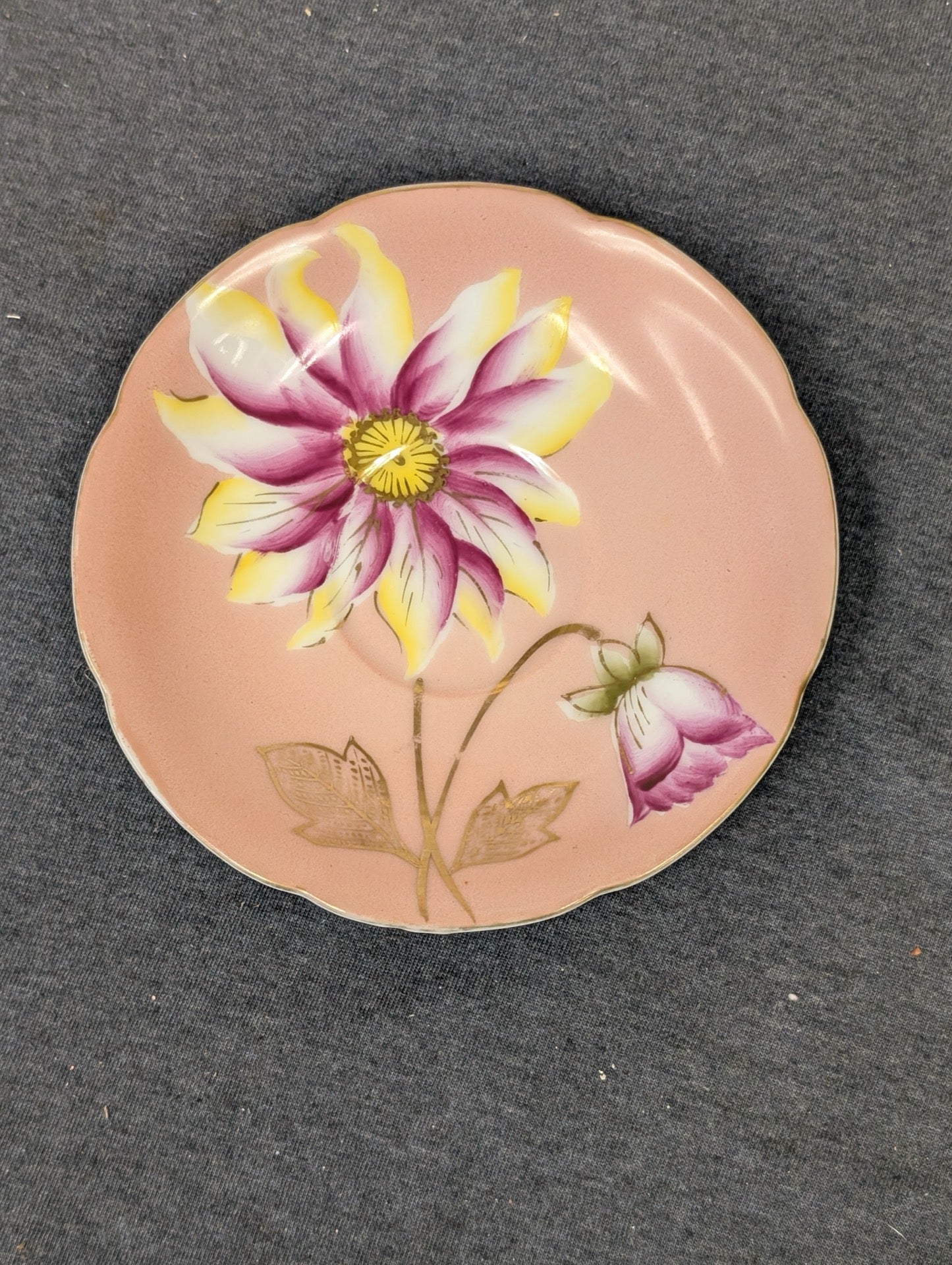 Vintage pink saucer made in Occupied Japan featuring a large hand-painted flower.