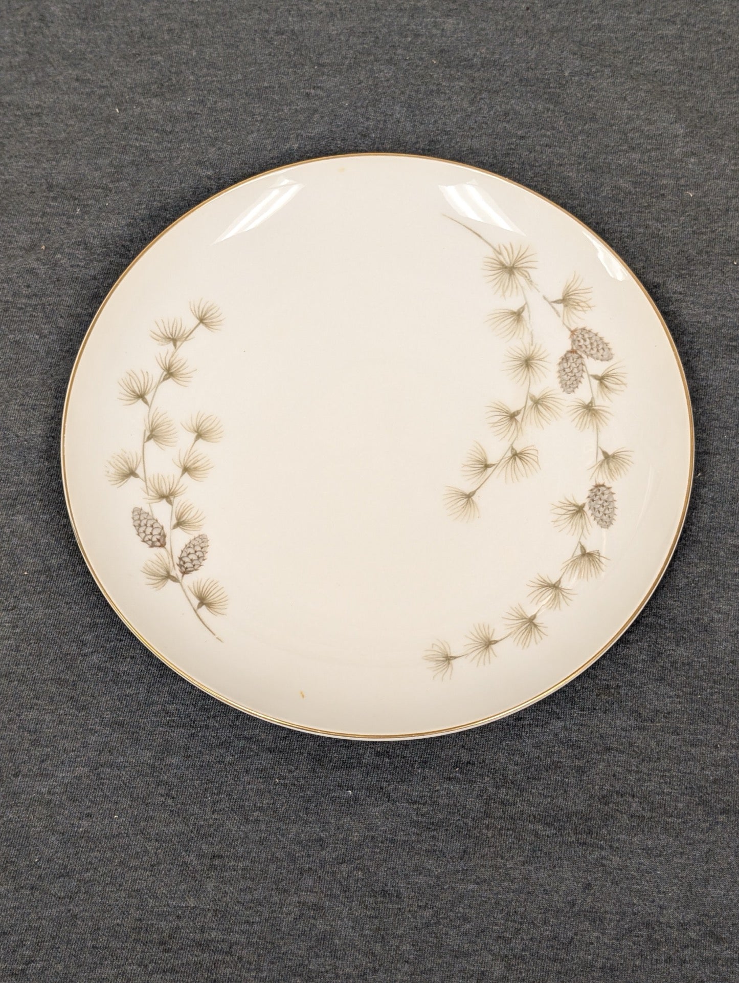 Front view of Mikasa Sequoia 6141 plate with pine needle pattern and gold rim