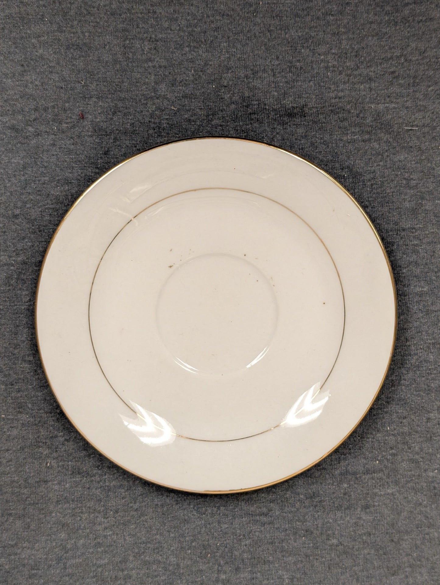 Top view of Sakura Classic Gold saucer with minor surface spots