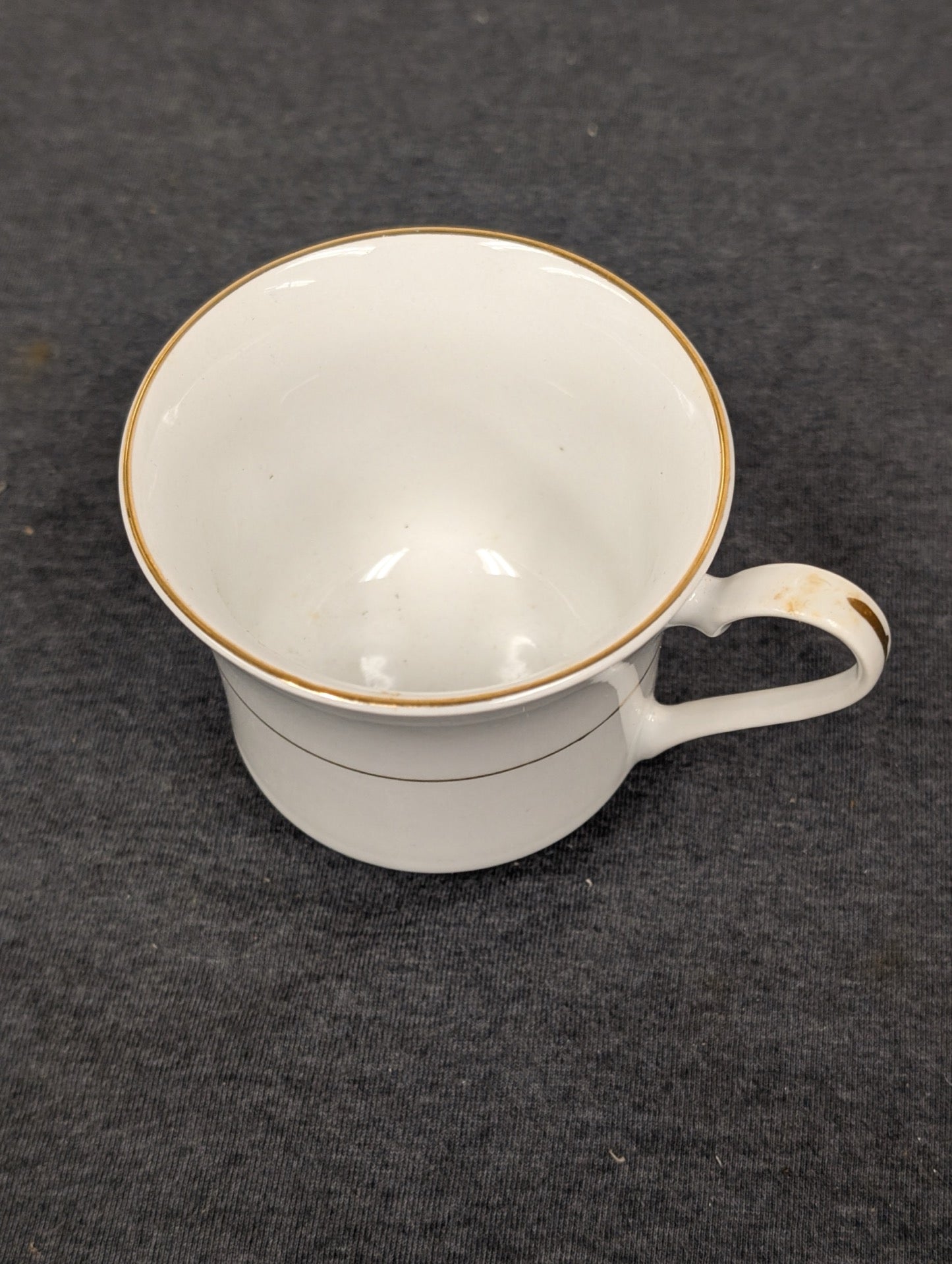 Sakura teacup showing visible brown staining and wear on the handle