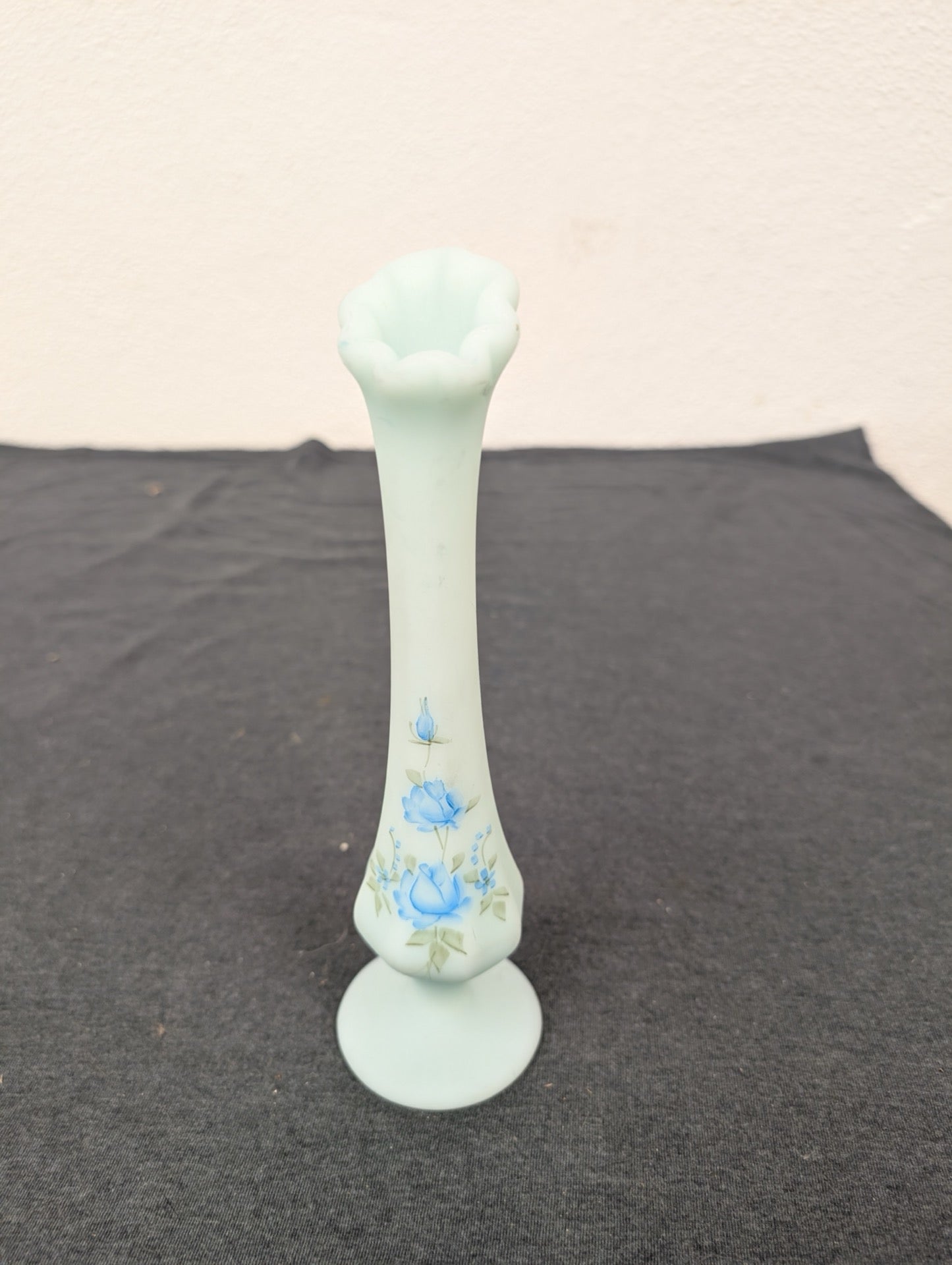 Tall, slender light blue milk glass vase with hand-painted blue roses on the bottom bulb.