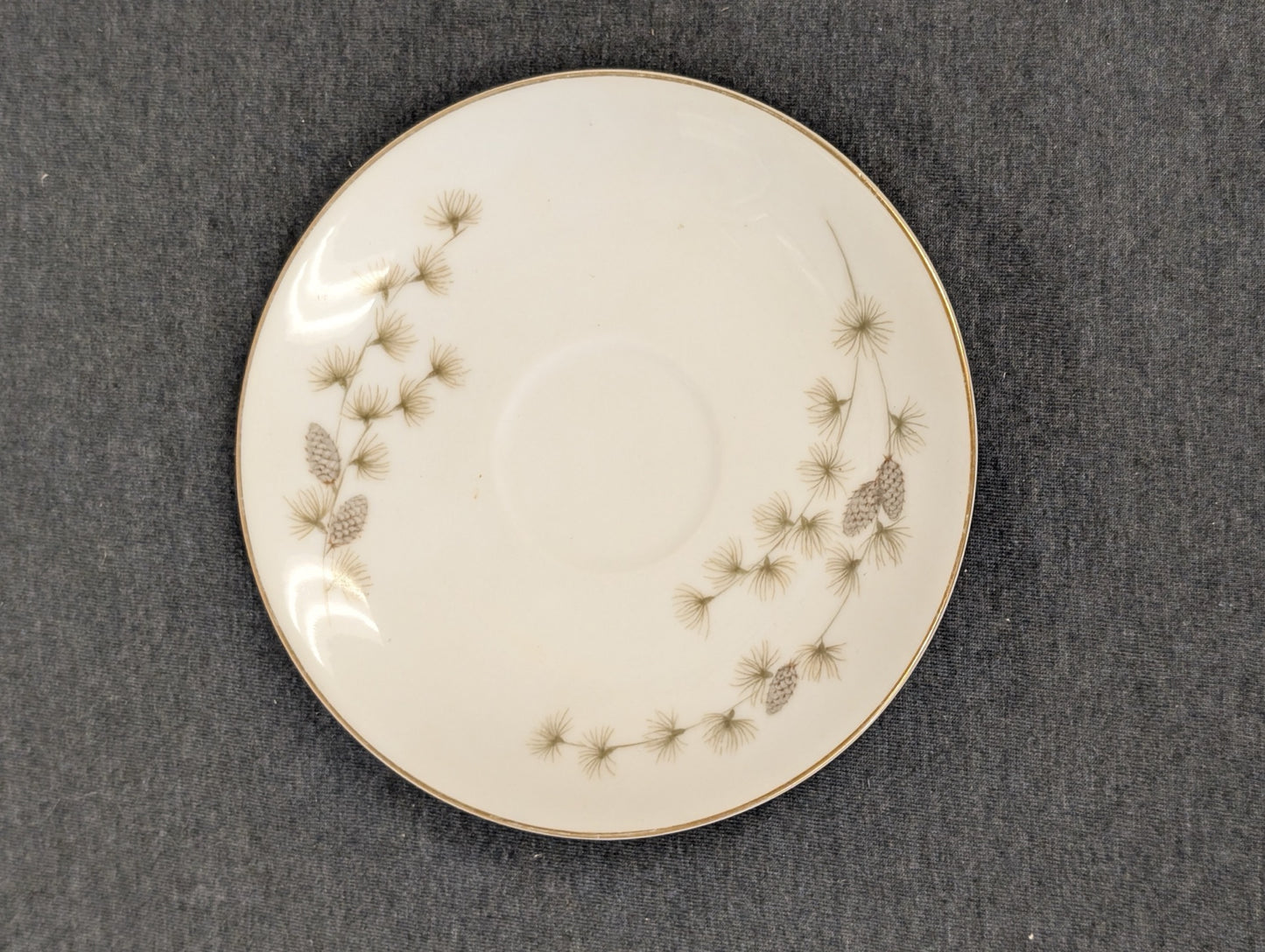Top view of vintage Mikasa Sequoia saucer with pinecone detailing