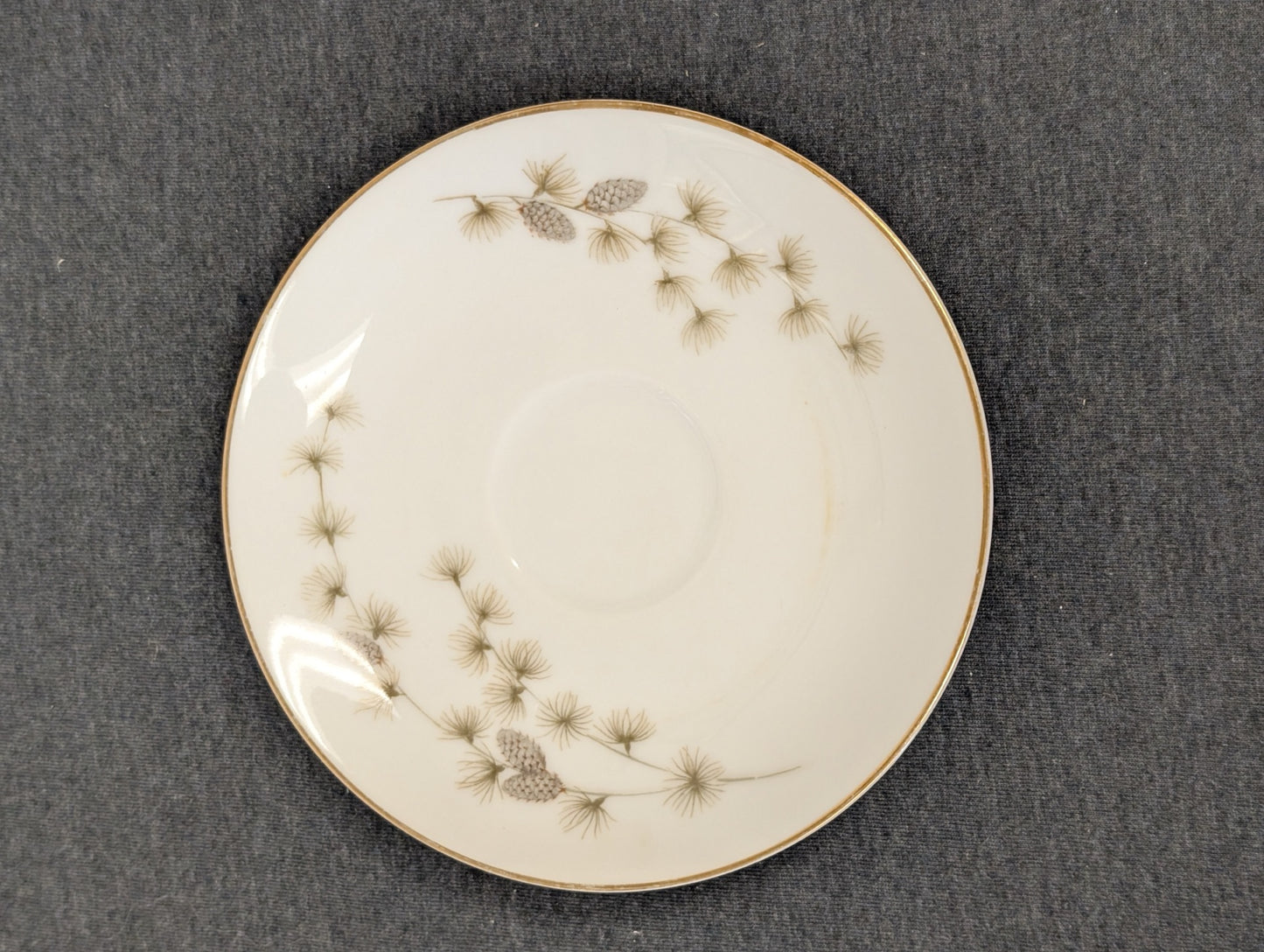 Vintage Mikasa Sequoia fine china saucer with pinecone pattern and gold rim.