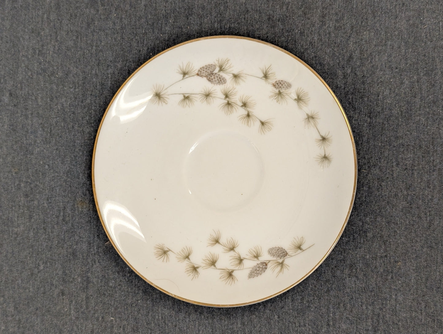 Pristine Mikasa fine china saucer showcasing elegant pinecones.