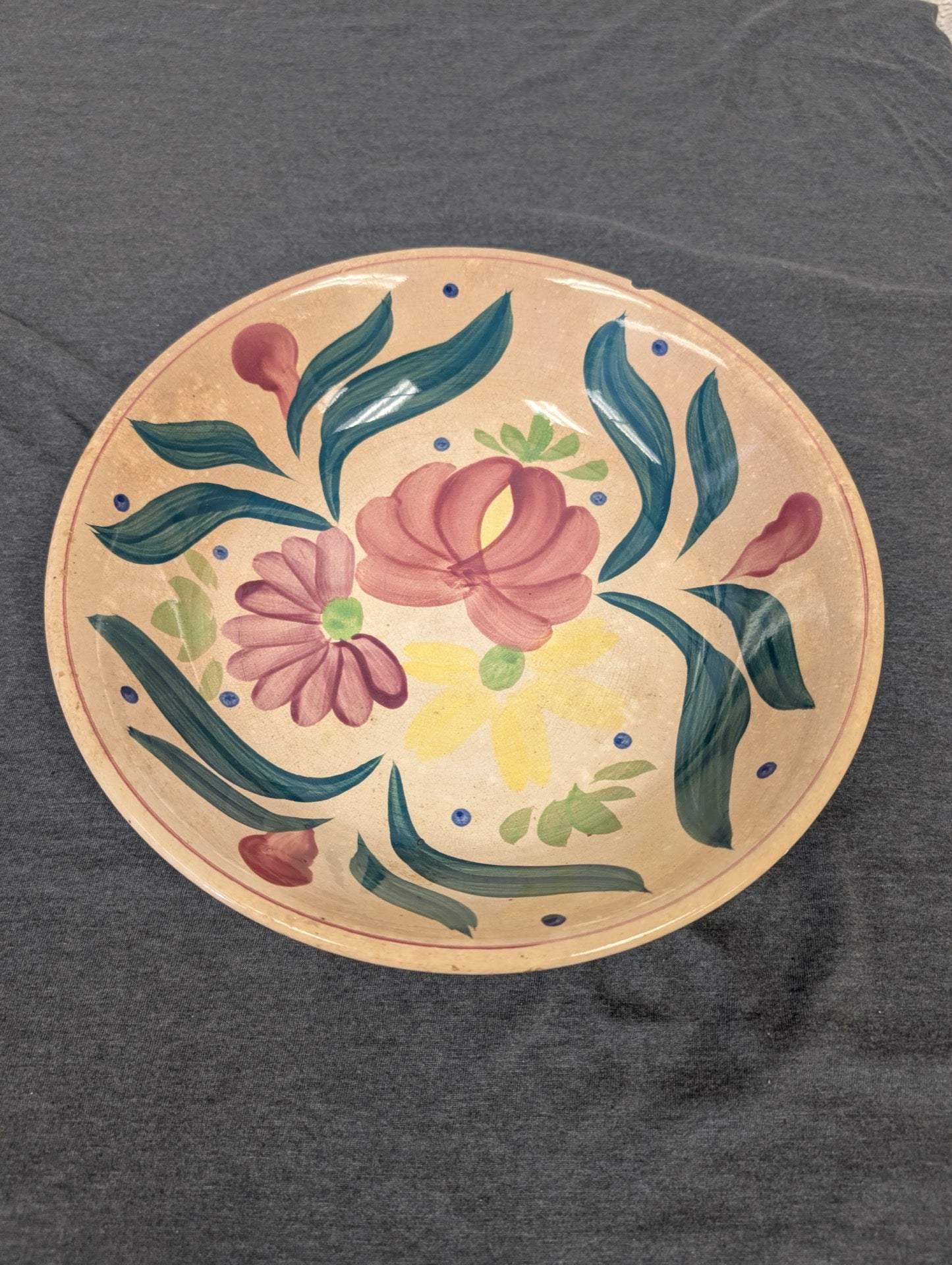 Ceramic bowl with hand painted pink and yellow flowers and green foliage