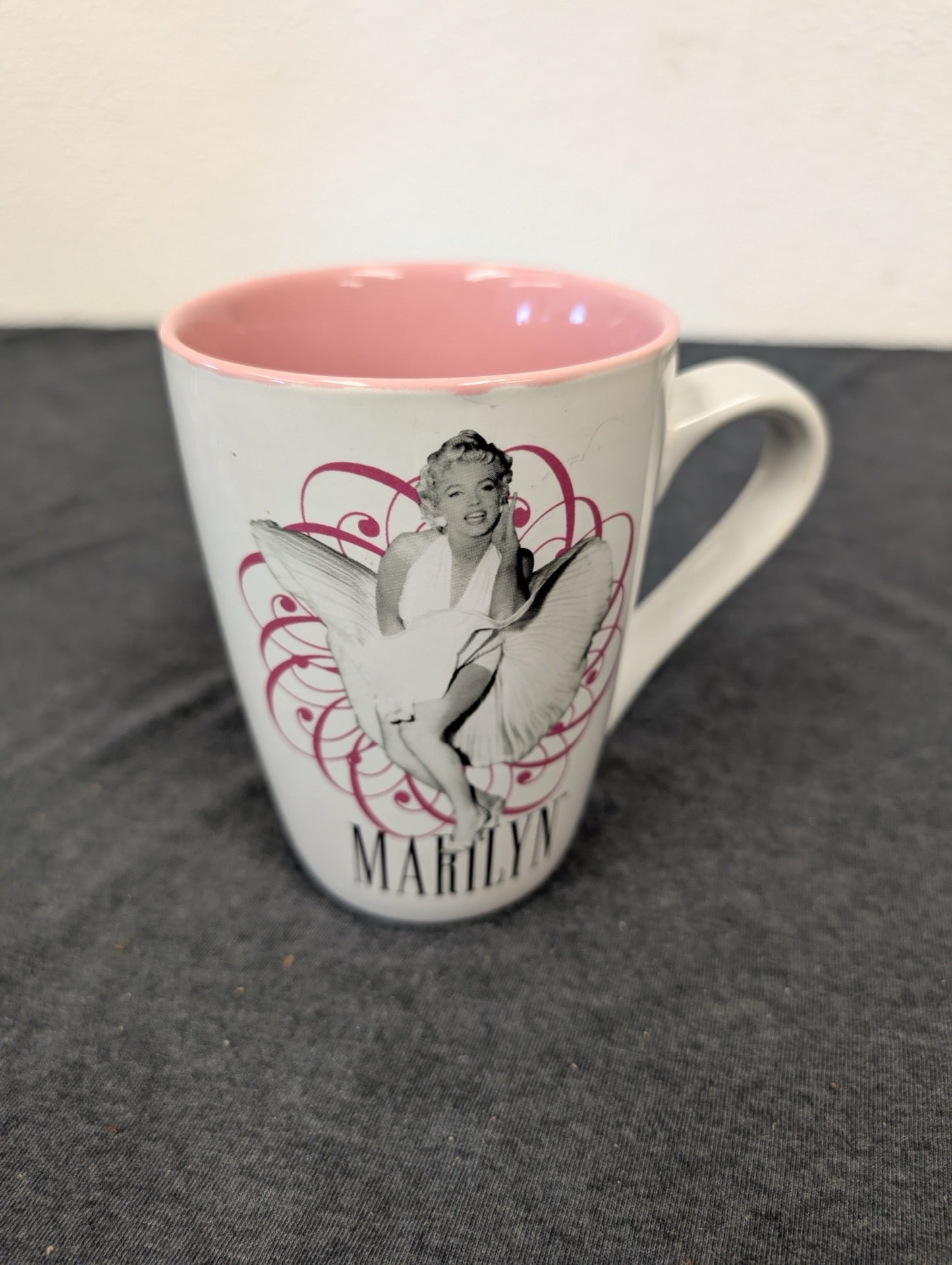 White ceramic mug with Marilyn Monroe in her classic white dress pose, pink interior.