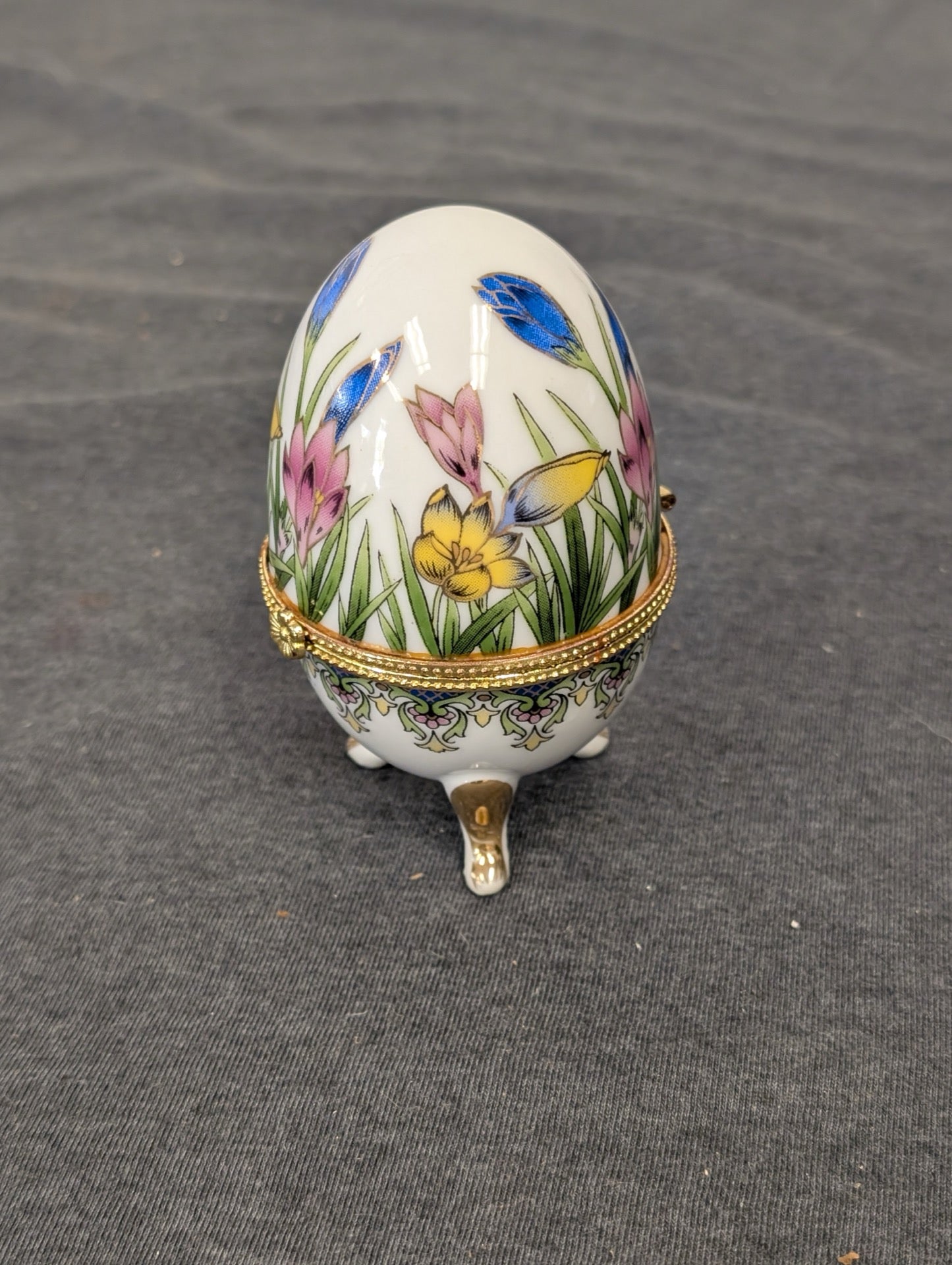 Closed porcelain egg shaped trinket box with pink and blue flowers