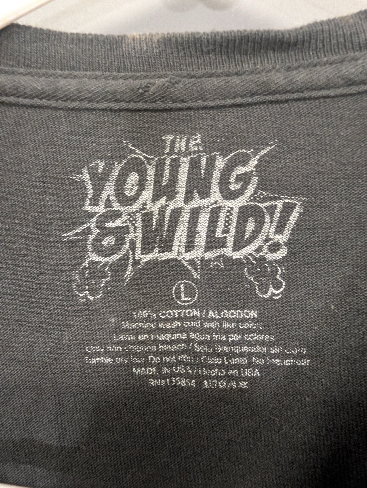 Shirt tag showing The Young and Wild brand and size Large