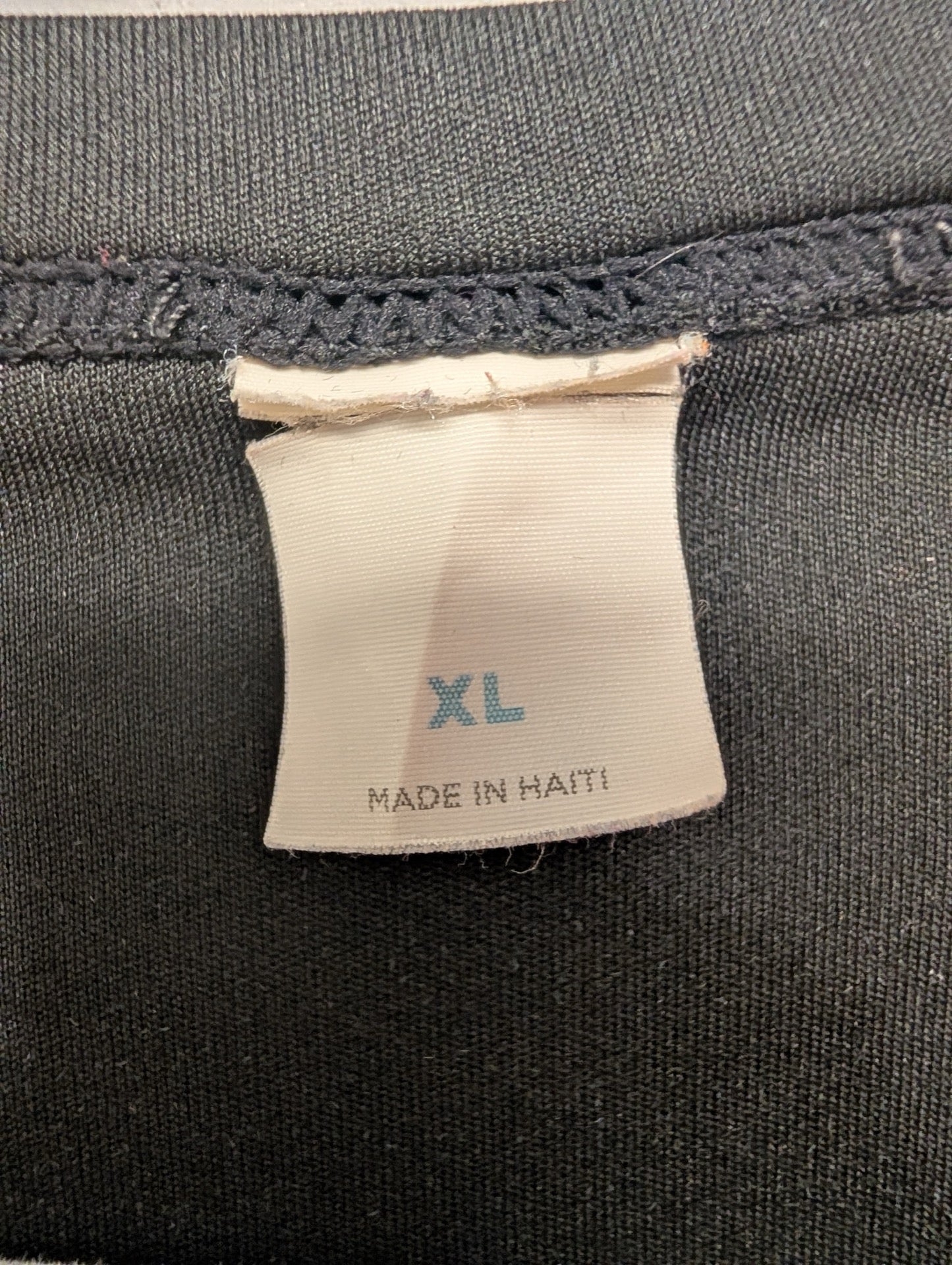 Faded tag showing size XL on black shirt