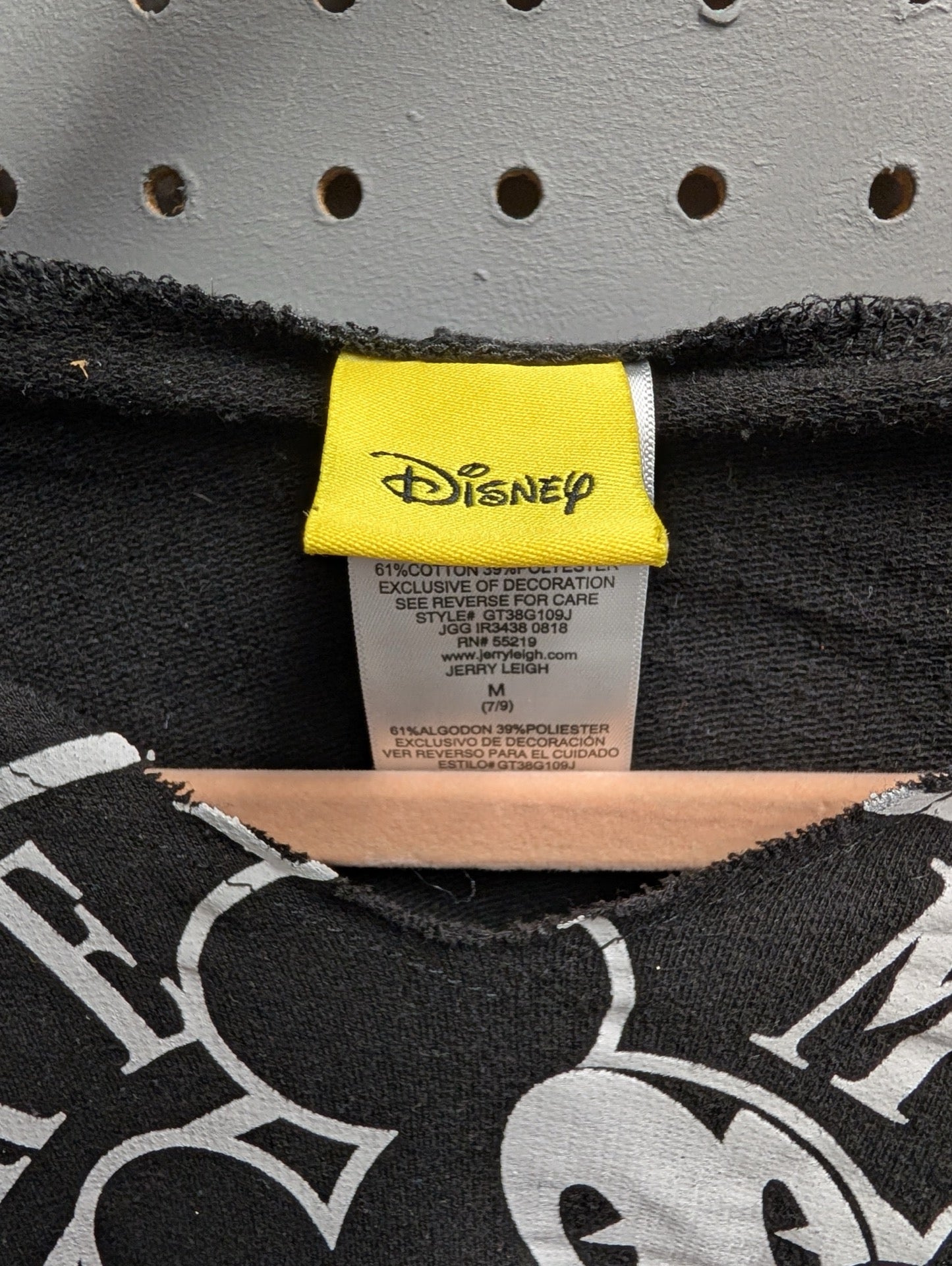Close up of yellow Disney Jerry Leigh tag size Medium