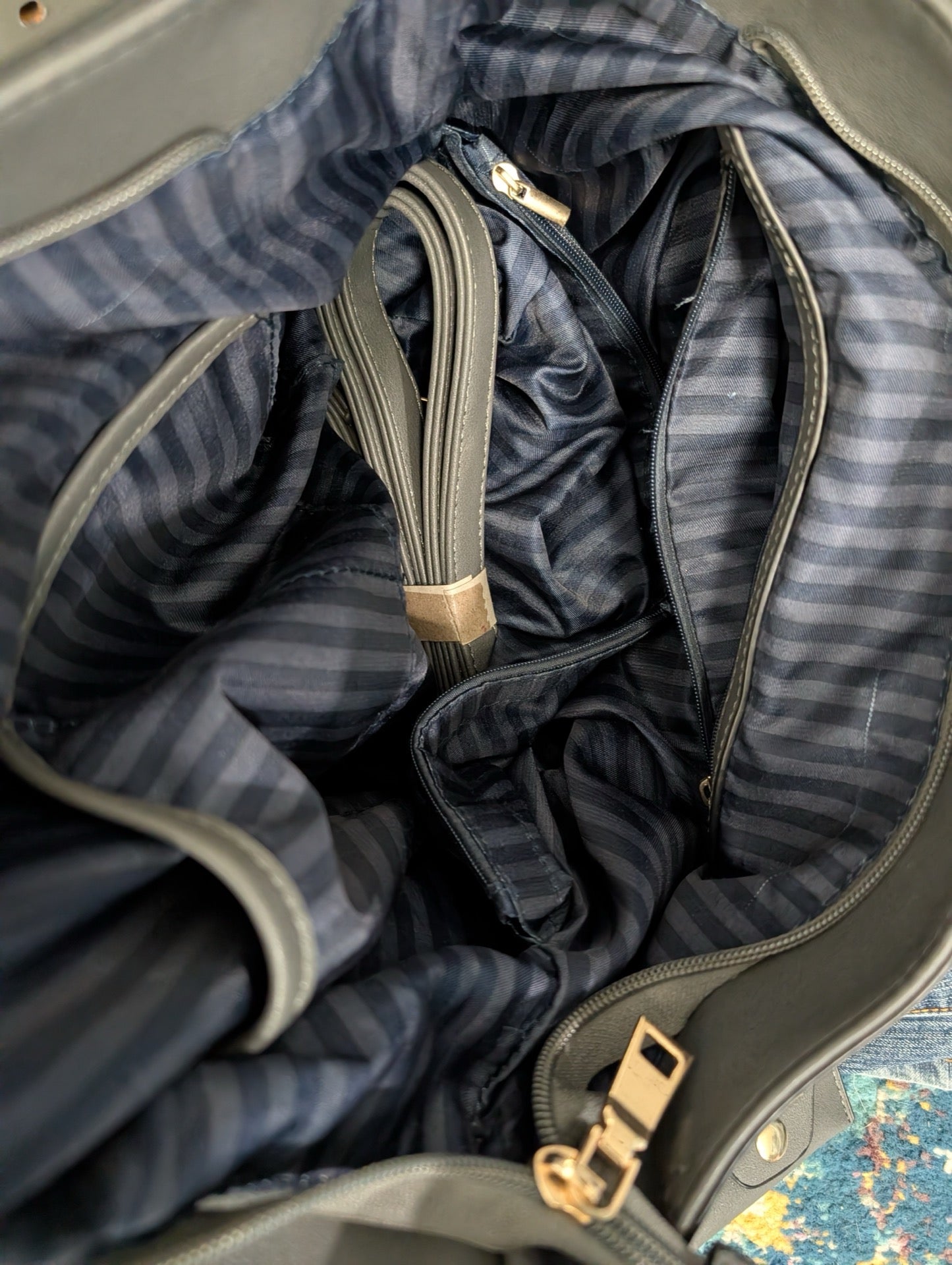 Interior view showing striped lining and matching strap