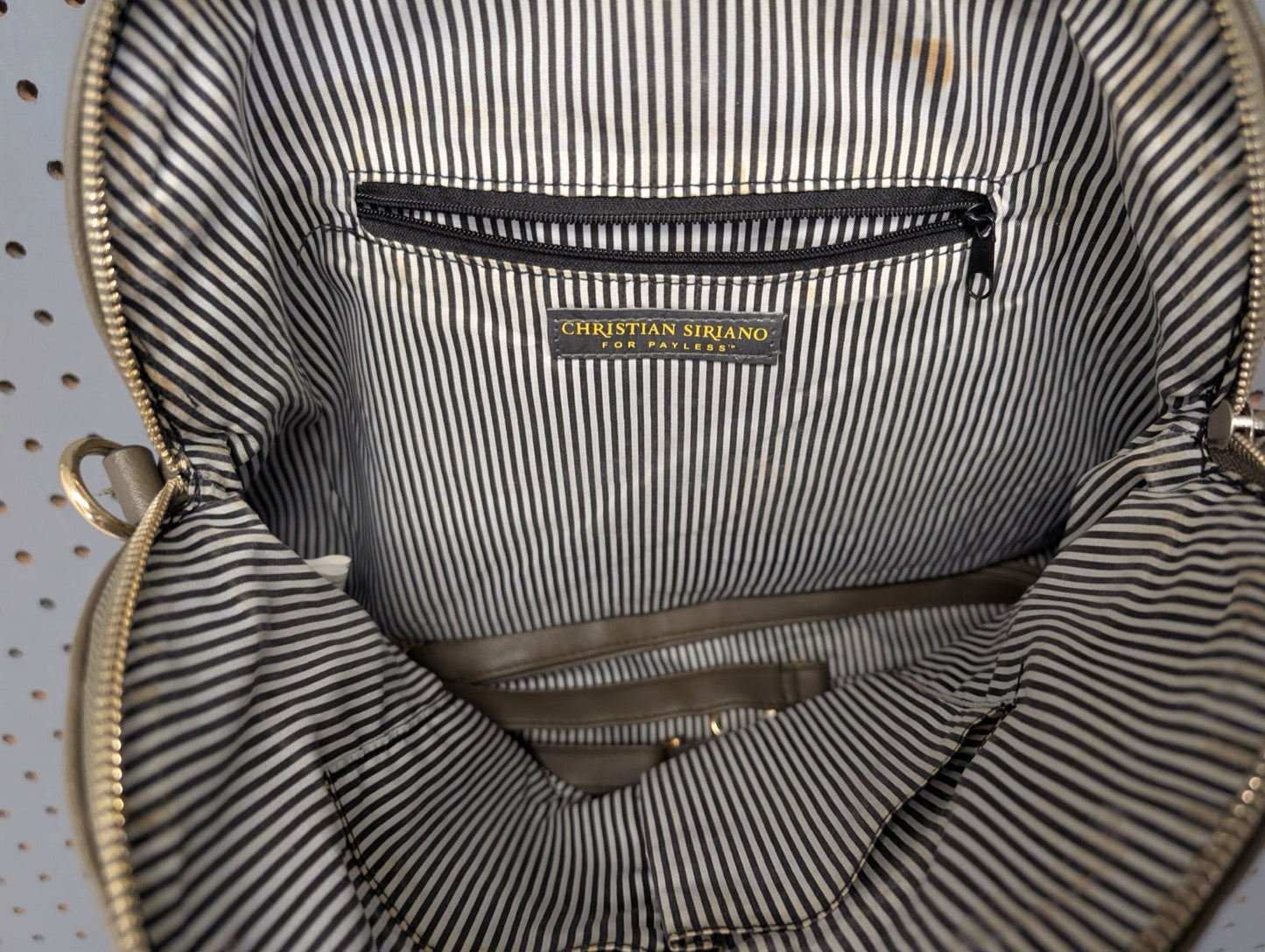 Interior view showing striped lining and tag