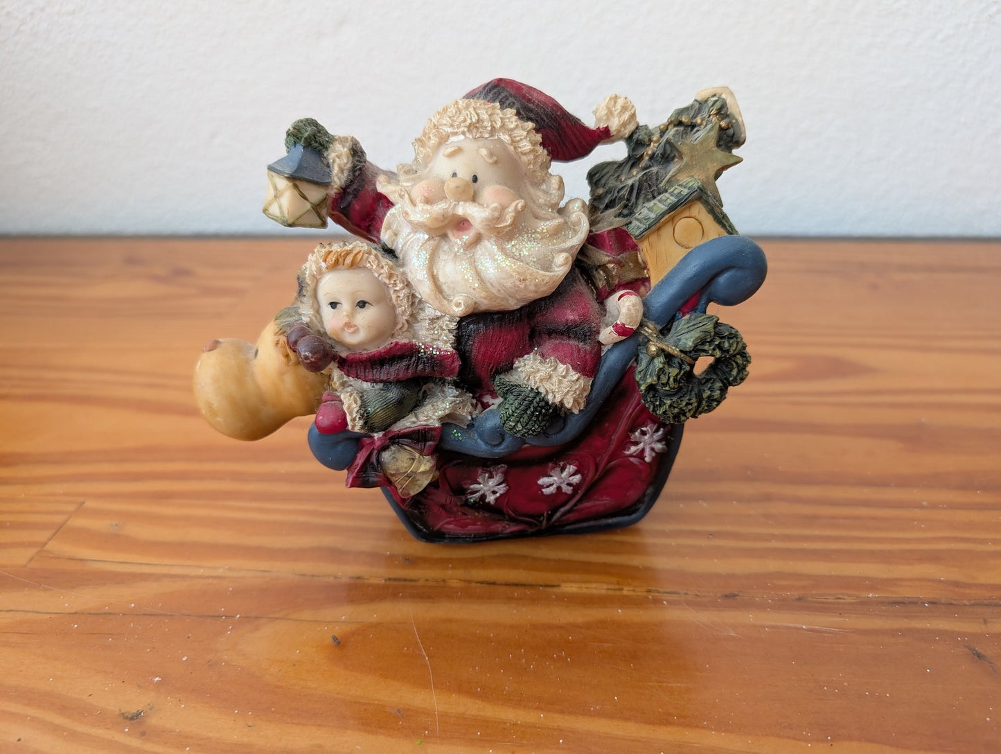 Santa and Child in Sleigh Figurine from Unknown -  Holiday Decor (Resin Figurine / Ornament, Whimsical, Folk Art, Red, Brown, Blue)
