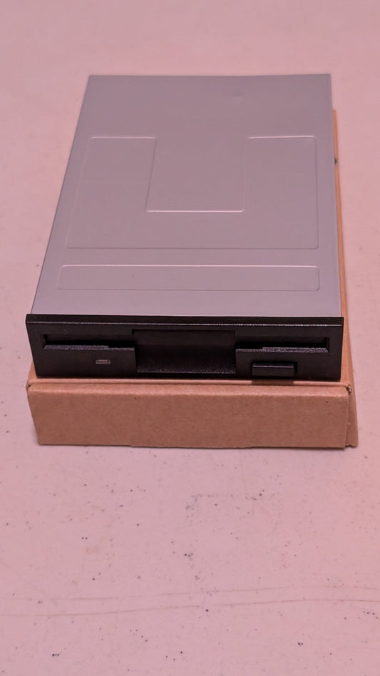 3.5-inch internal floppy disk drive from Generic - 1990s Computer Components (Metal, Plastic, PCB Floppy Drive, Retro Tech, Utilitarian, Silver, Black)