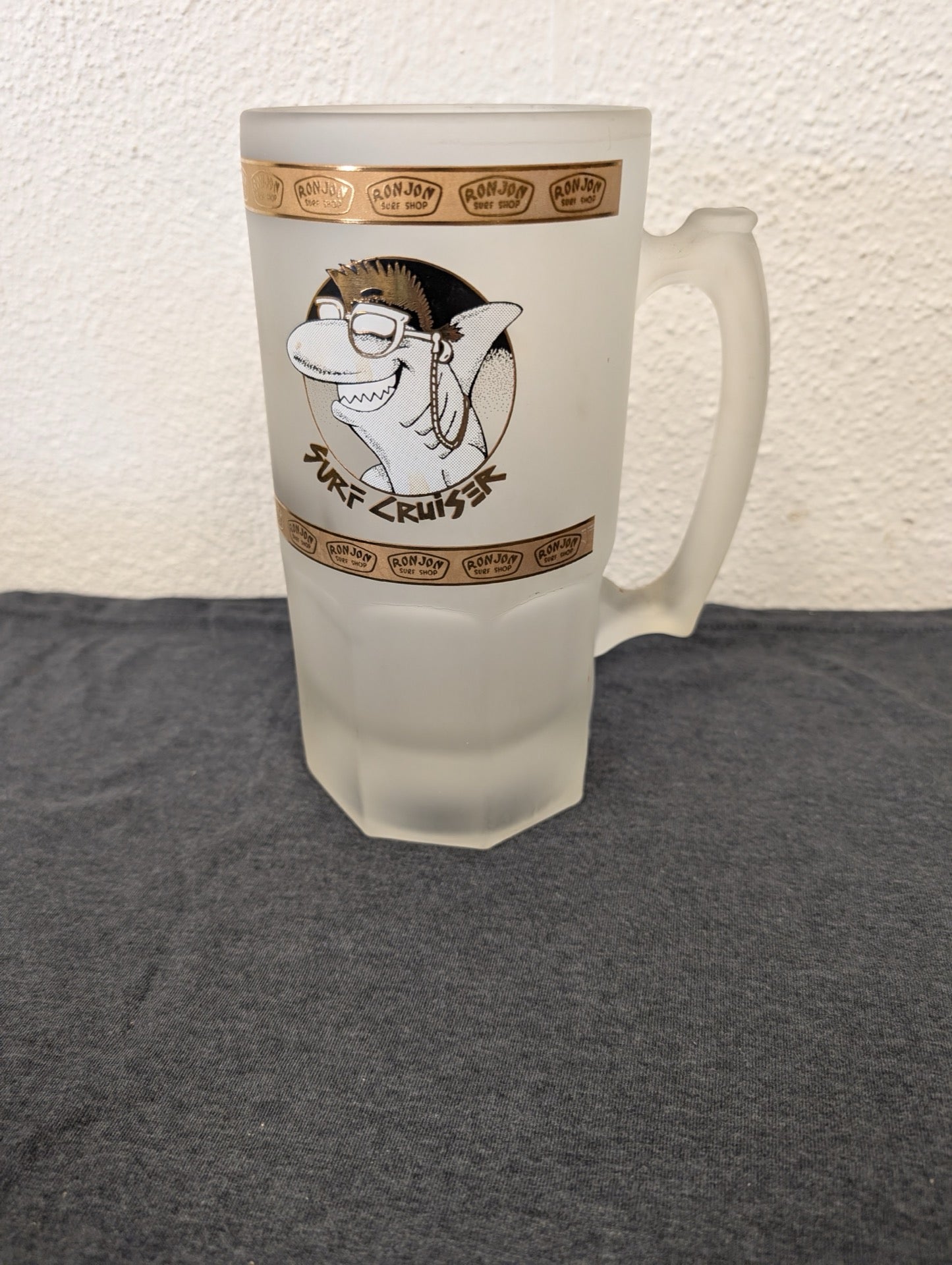 Tall frosted glass stein with a Ron Jon Surf Shop Surf Cruiser shark logo.