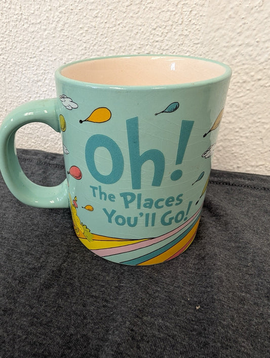 Mint green mug with Oh! The Places You'll Go text and Dr. Seuss balloon art.