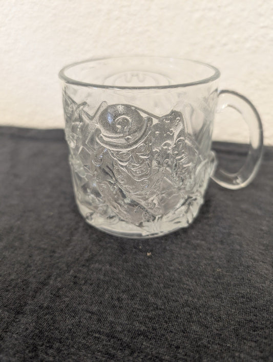 Clear glass mug deeply embossed with The Riddler character holding his cane.