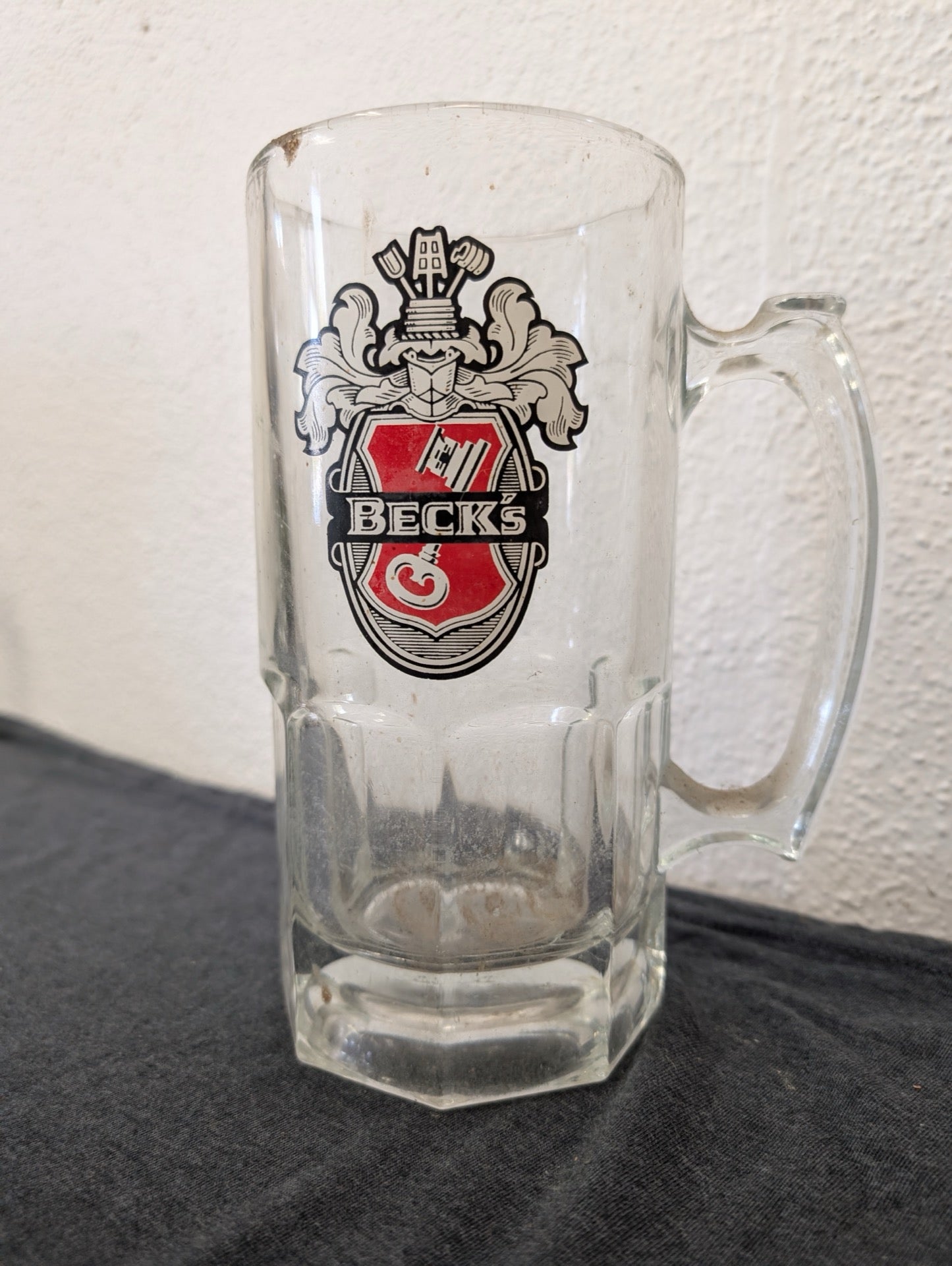 Heavy clear glass beer stein with the Beck's Beer key crest logo printed on it.