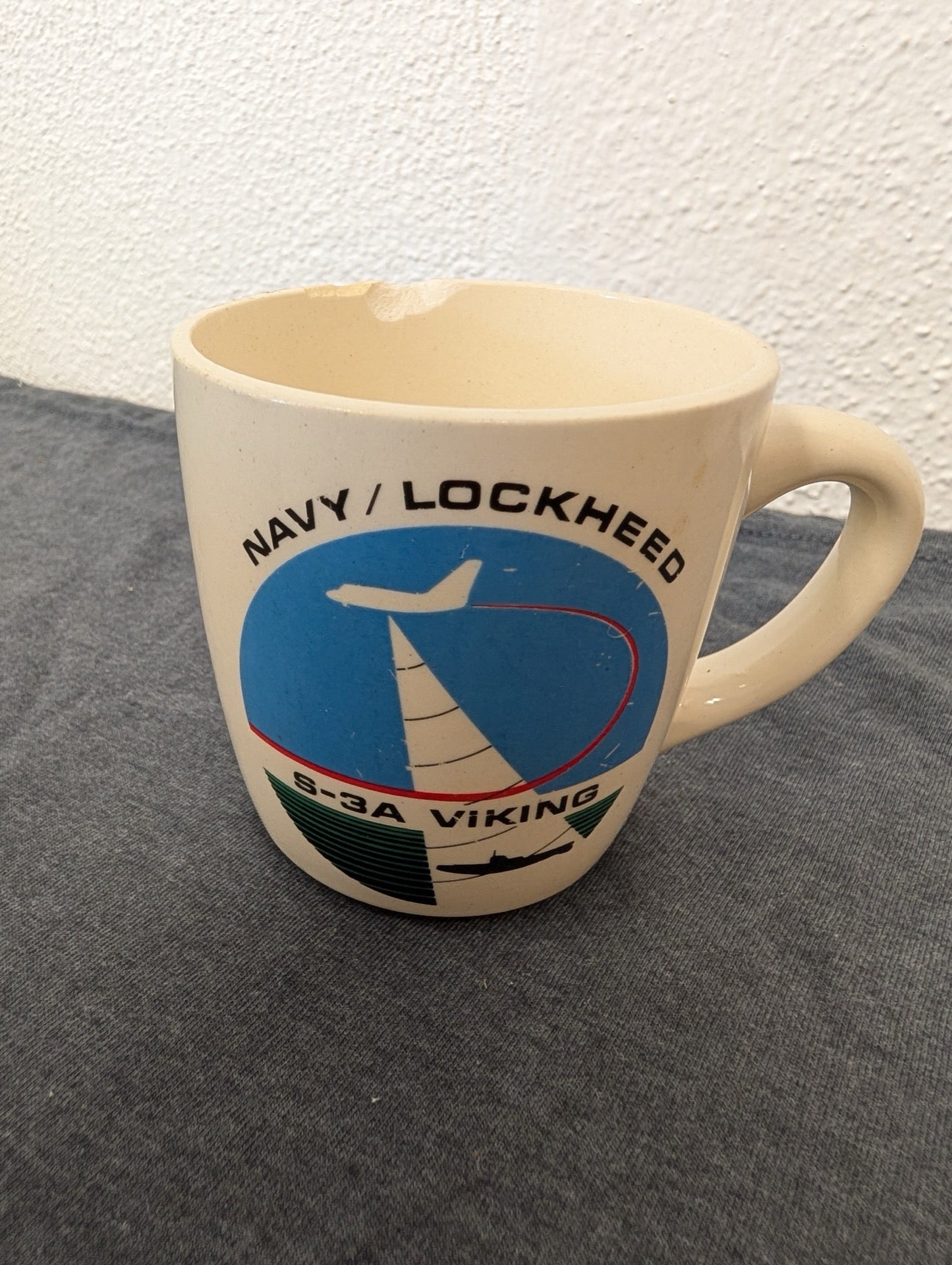 Off-white mug with a blue graphic of a jet plane and text reading Navy Lockheed S-3A Viking.
