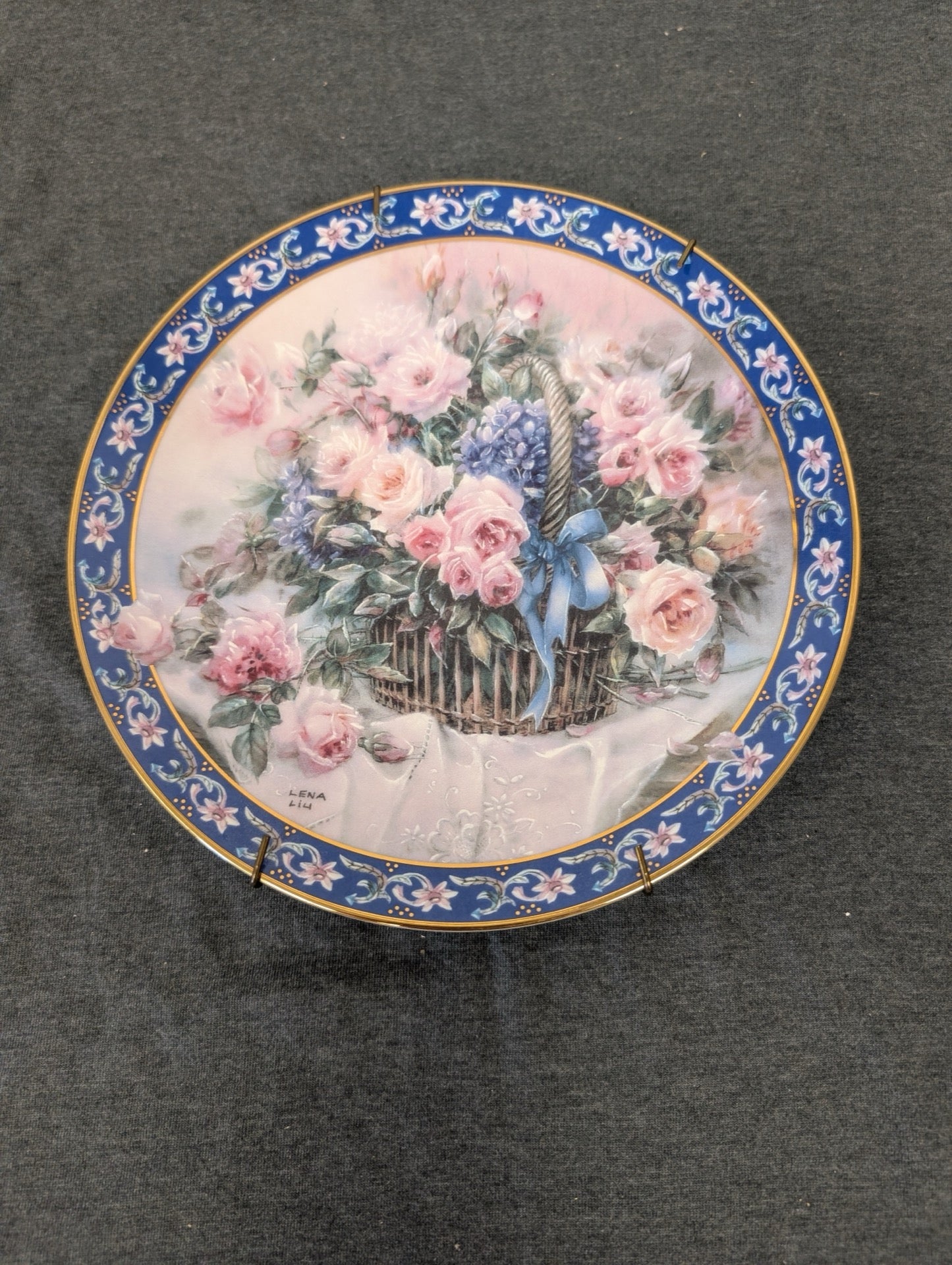 Lena Liu collector plate featuring pink roses in a basket with a blue ribbon