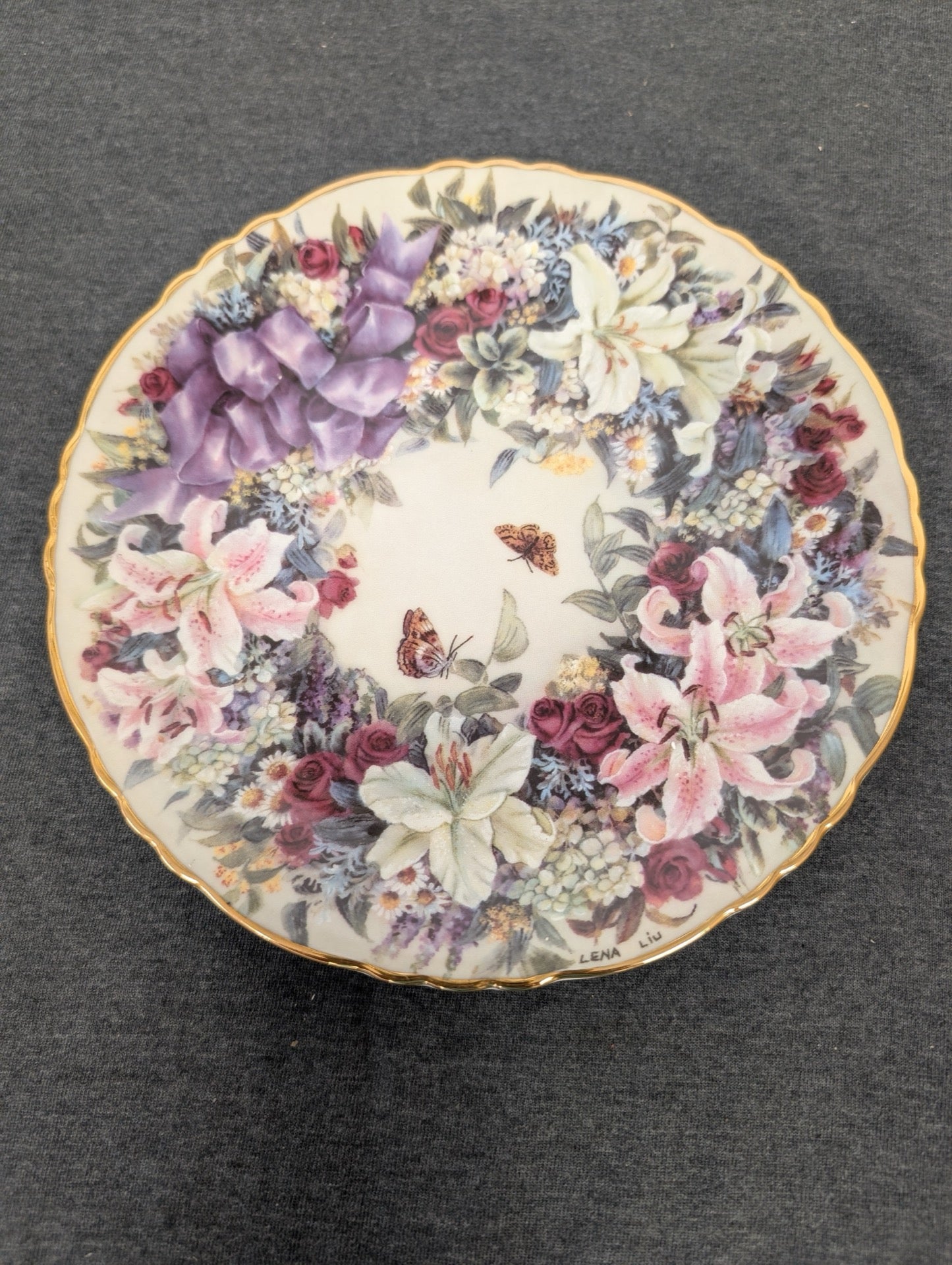 Porcelain plate featuring a wreath of lilies, roses, and butterflies by Lena Liu.