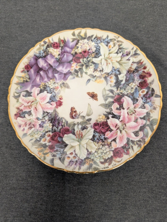 Porcelain plate featuring a wreath of lilies, roses, and butterflies by Lena Liu.