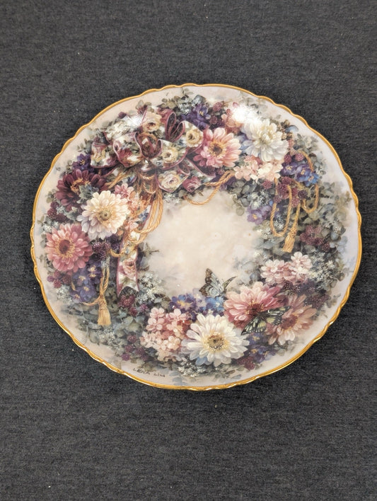 Porcelain plate featuring a wreath of pink and white mums, berries, and a golden braided rope.