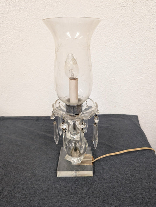 Electric table lamp with a clear square base, hanging crystal prisms, and a glass shade.