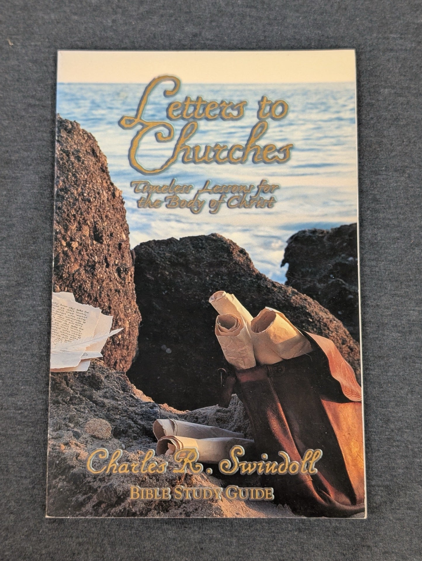 Cover of Letters to Churches Bible Study Guide by Charles Swindoll showing scrolls on a rocky shore.