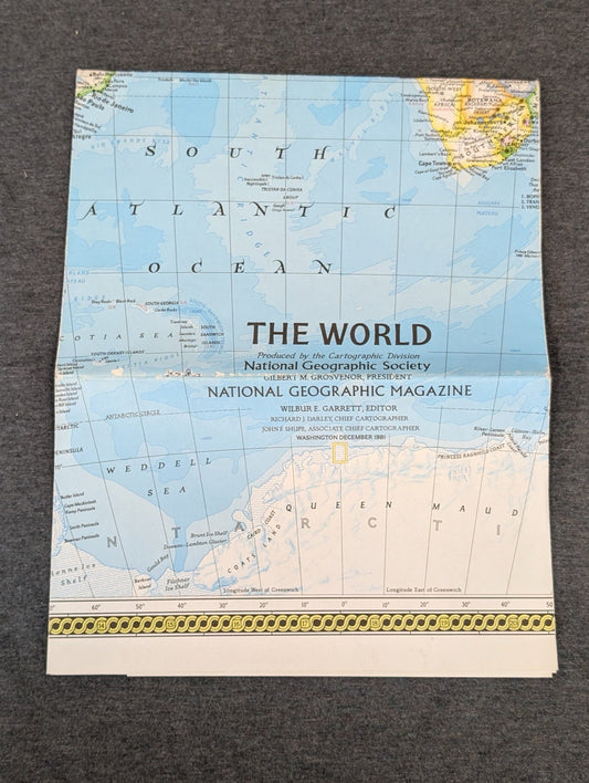Folded vintage National Geographic map of The World from December 1981 showing the Antarctic coast.