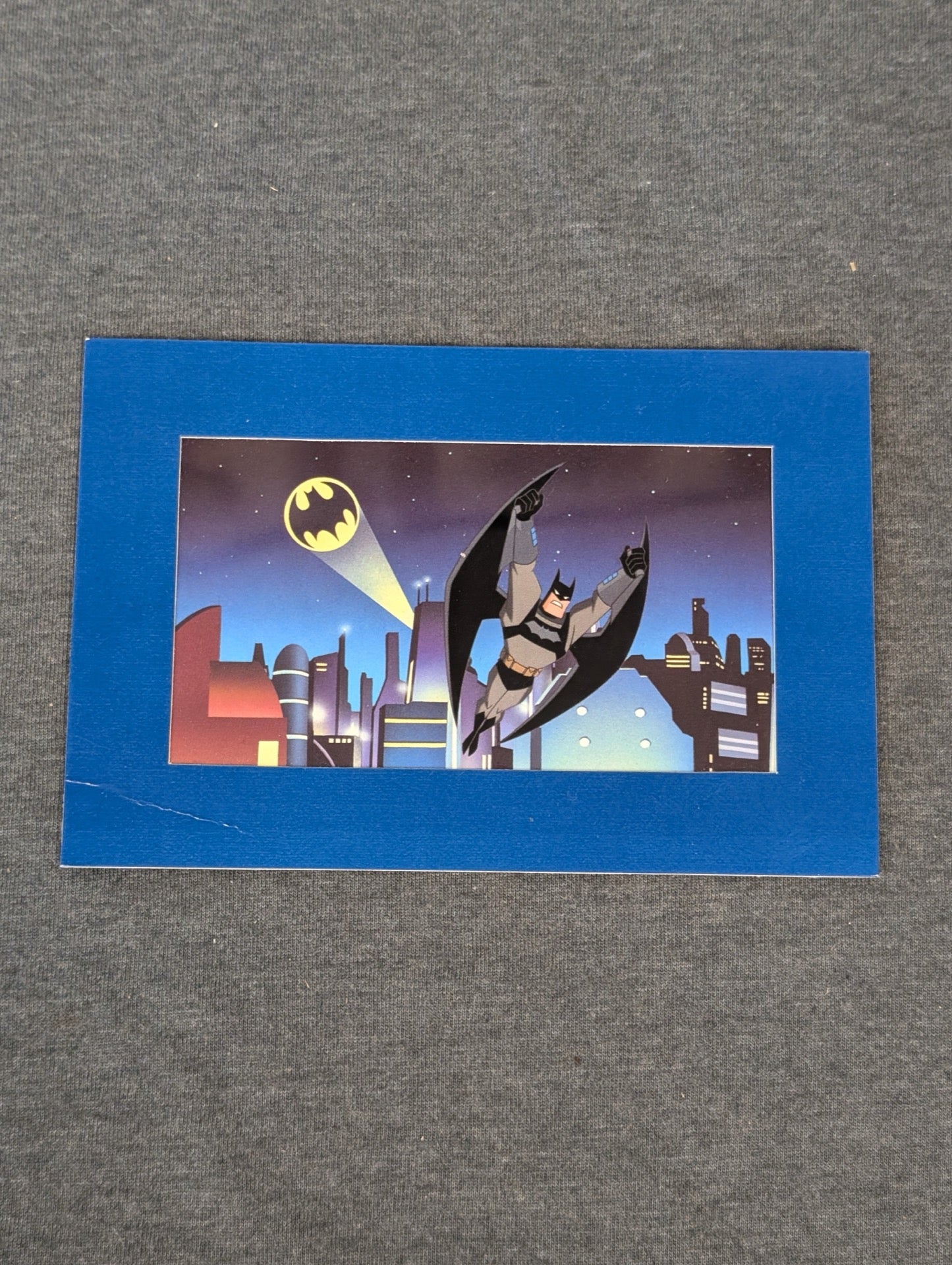 Batman gliding over Gotham City from the Animated Series on a postcard