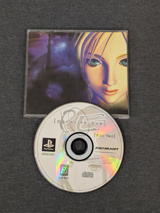 Parasite Eve PS1 Disc Two and the front cover of the manual featuring Aya