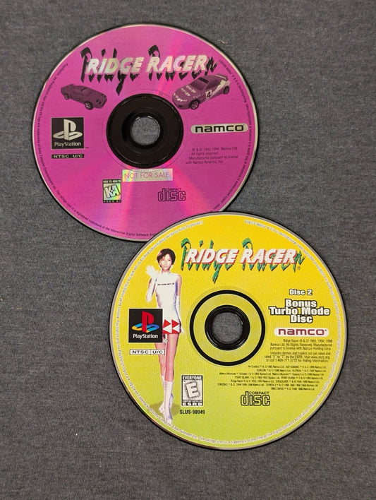 Ridge Racer PS1 pink original disc and yellow Bonus Turbo Mode disc