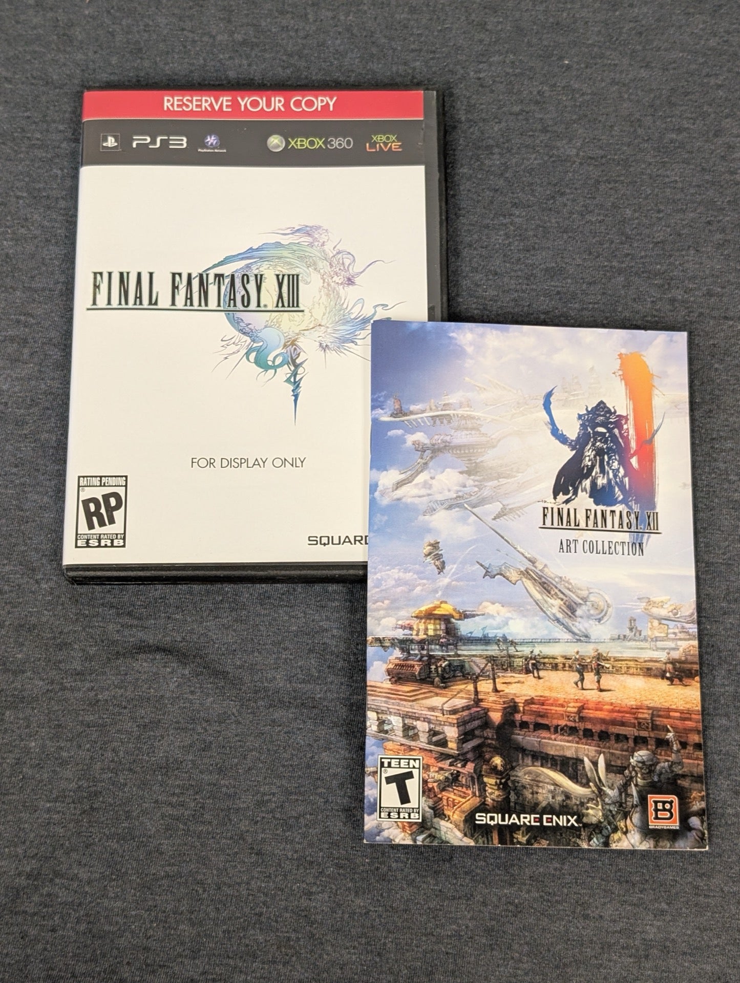 Empty Final Fantasy XIII retail display case and Final Fantasy XII art booklet. No game included.