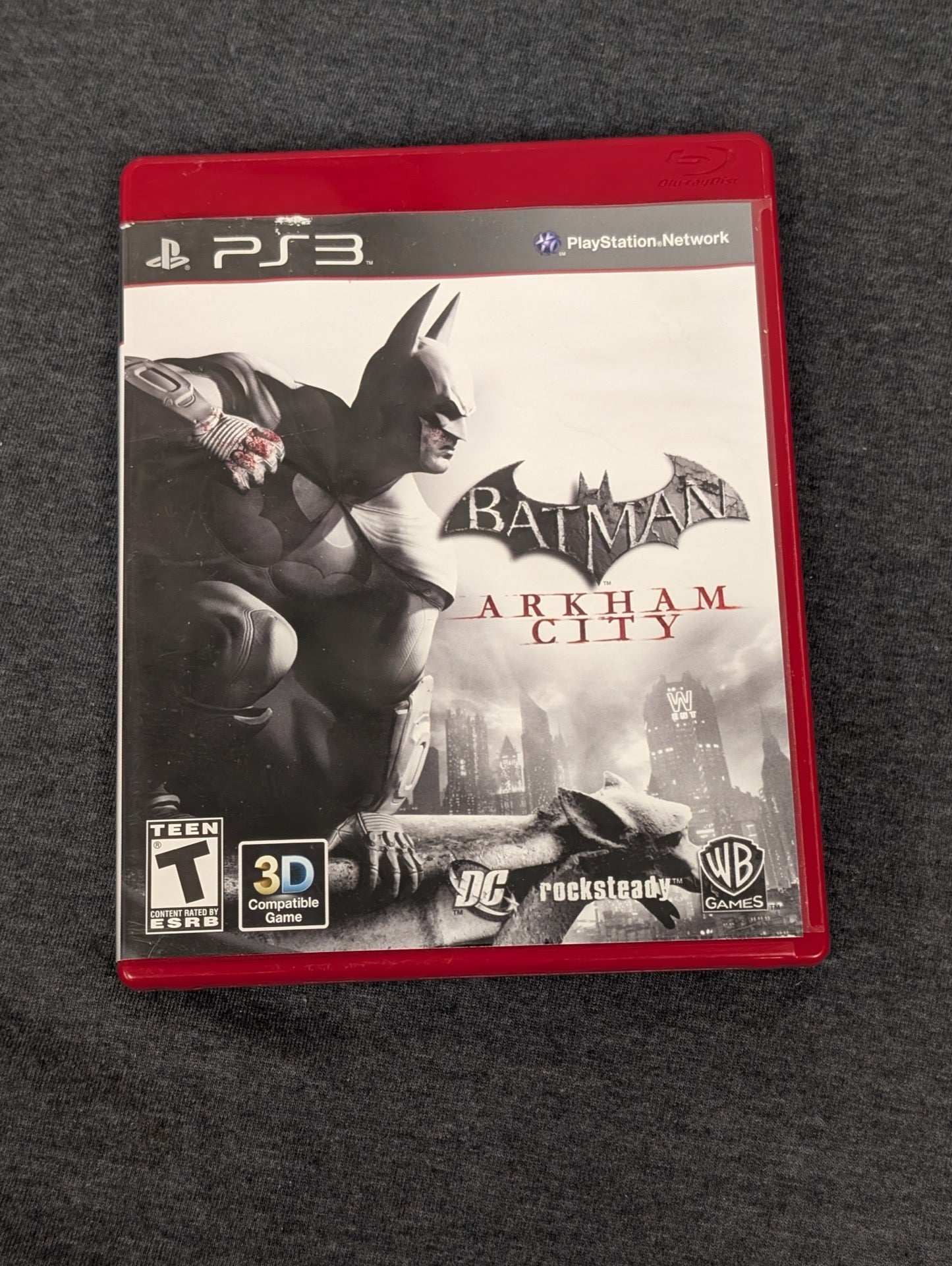 Batman Arkham City empty red PS3 game case. No disc included.