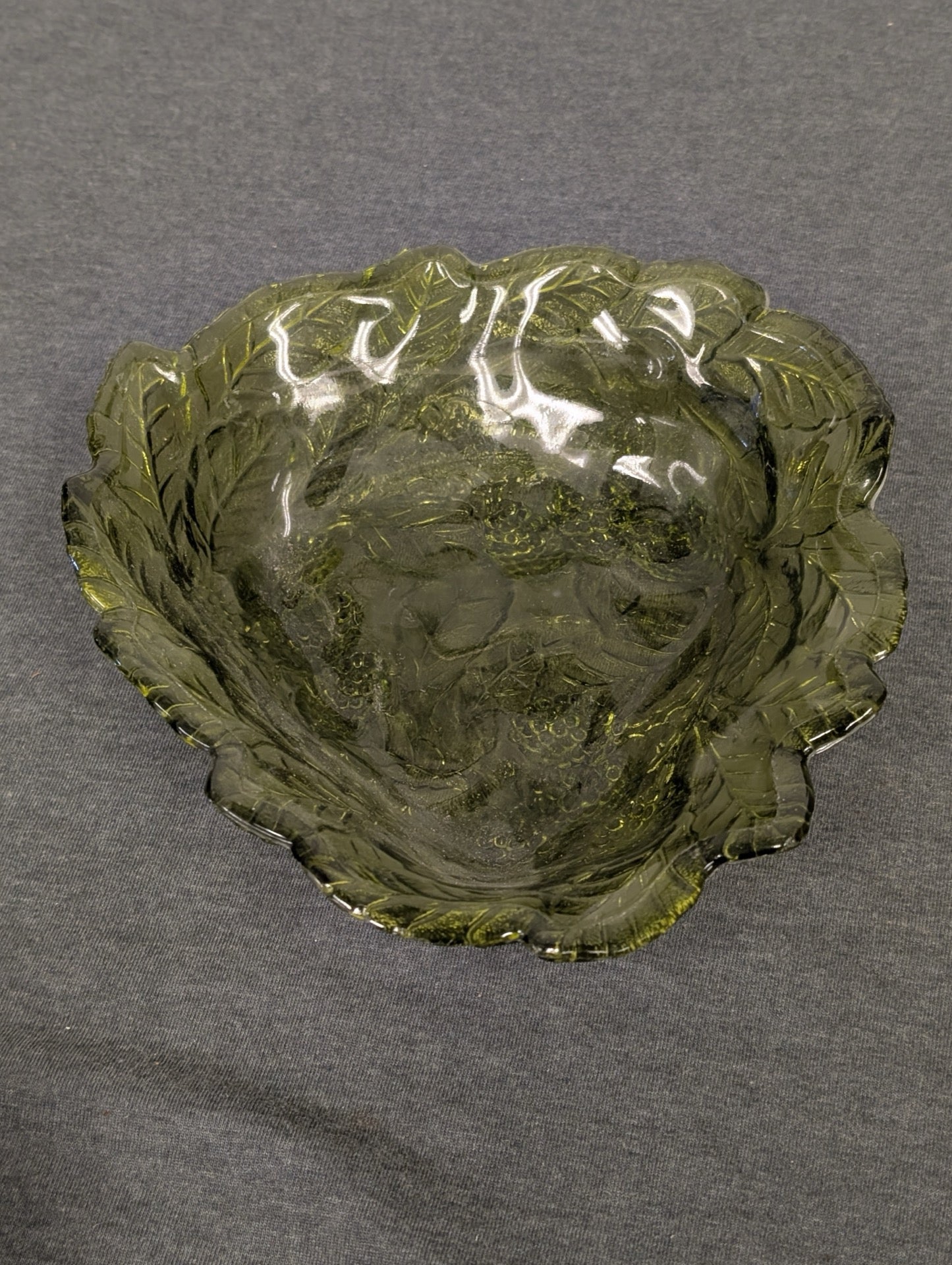 Vintage green glass bowl molded in the shape of a textured leaf.