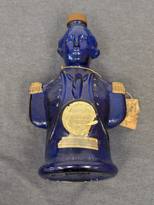 Blue glass figural bottle shaped like George Washington with original paper labels.