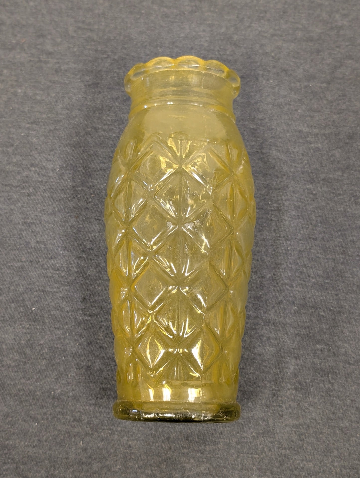 Yellow vintage glass jar with a textured diamond or pineapple pattern.