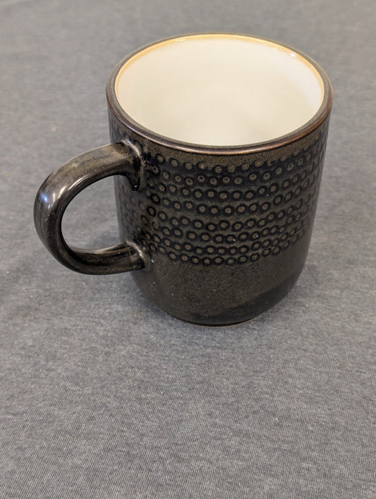 Dark brown glazed stoneware mug with a band of raised circular textures.
