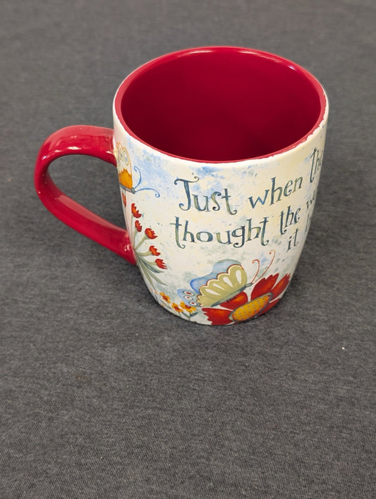 Ceramic coffee mug with floral designs and the quote Just when the caterpillar thought the world was over.