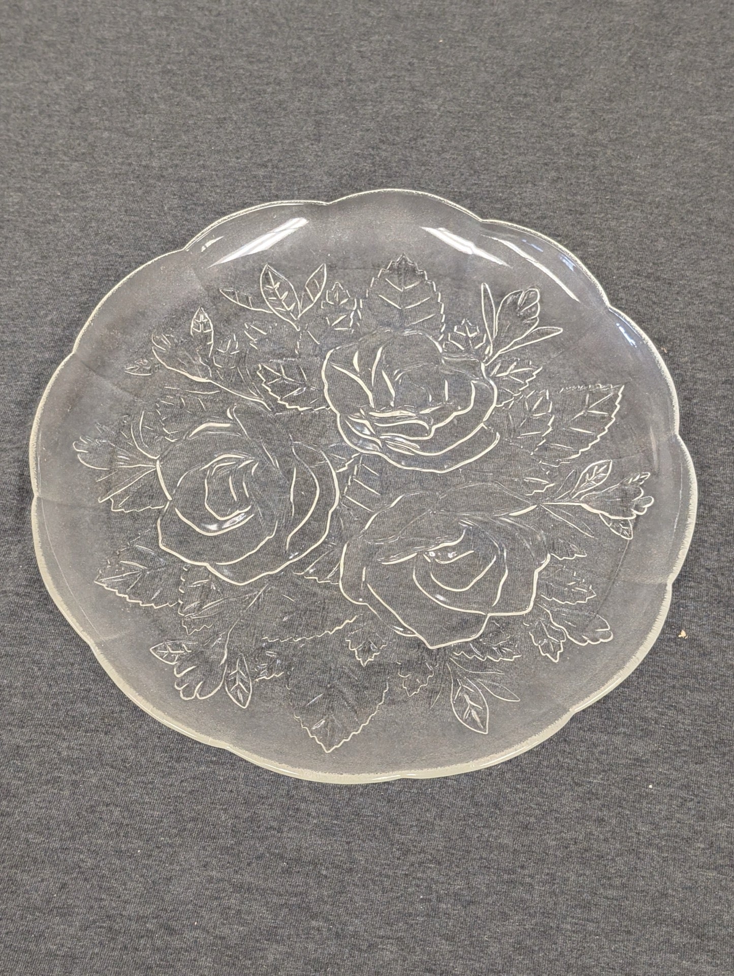 Clear glass plate with an embossed design of three large roses and leaves.