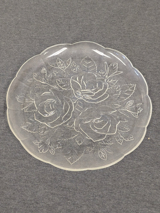 Clear glass plate with an embossed design of three large roses and leaves.