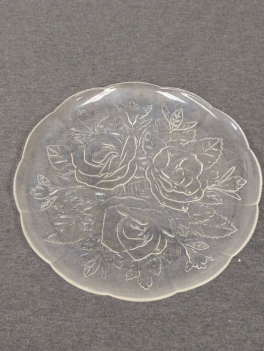 Clear glass plate with an embossed design of three large roses and leaves.